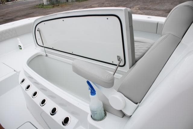 2025 Freeman 35 boat interior with open storage compartment and cleaning supplies.