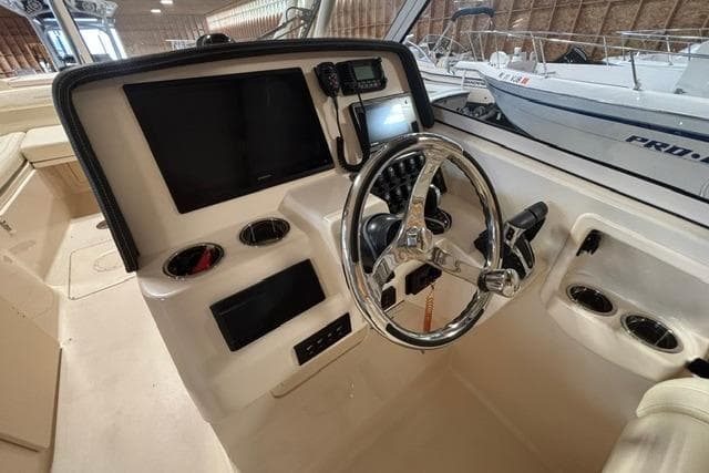 2022 Grady-White Freedom 285 boat helm with steering wheel and control panel.