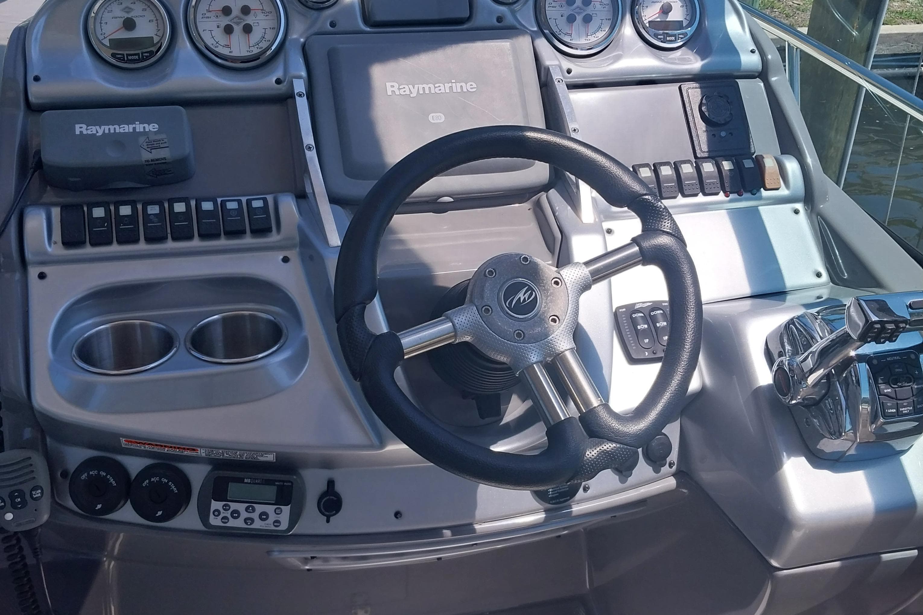 Steering console of a 2011 Monterey 340 Sport Yacht with Raymarine electronics.