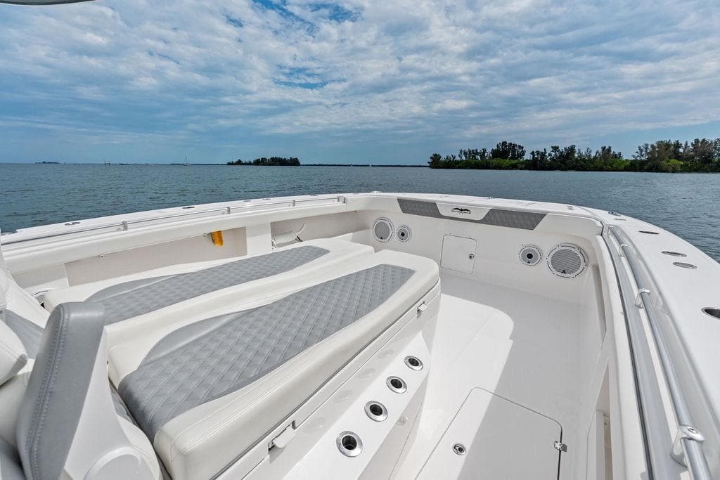 Invincible 46 Catamaran 2021, spacious deck with seating, ocean view, clear sky.