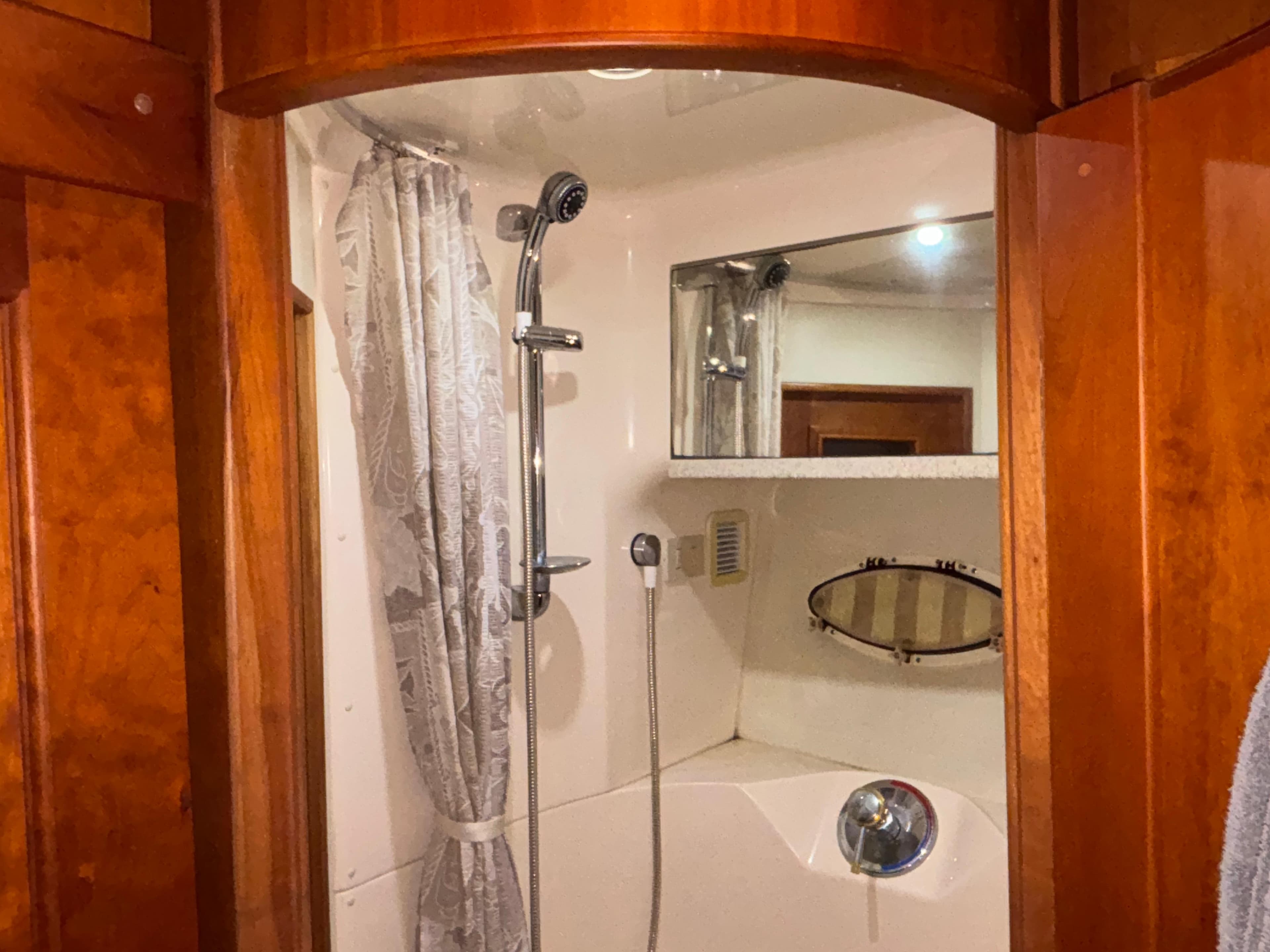 Bathroom interior of 2001 Silverton 410 Sport Bridge with shower and wooden accents.