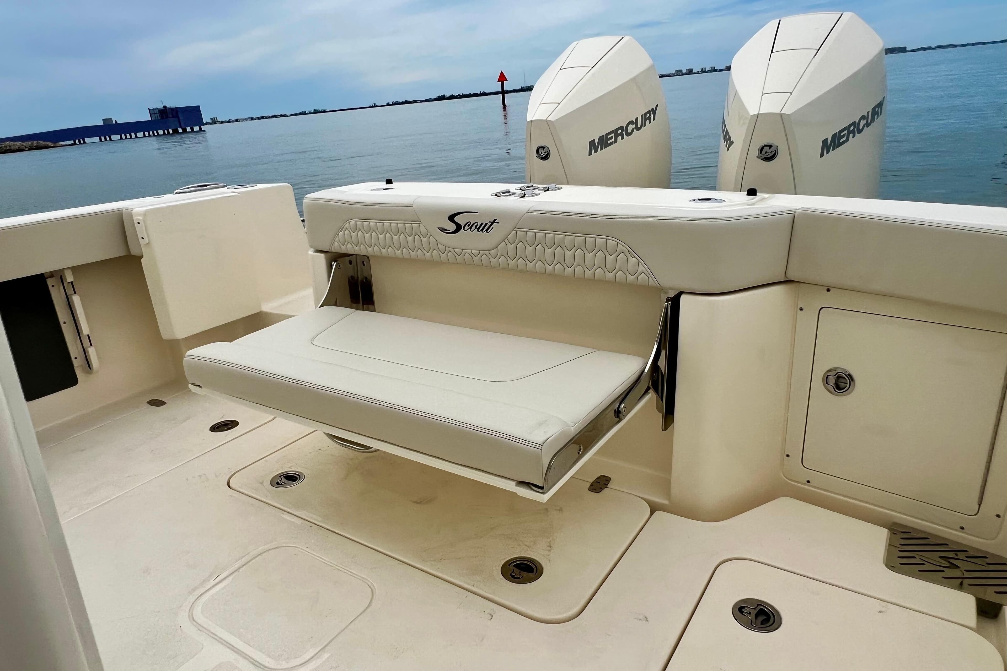 2026 Scout 288 LXF boat with Mercury engines, featuring a foldable seat and storage compartments.