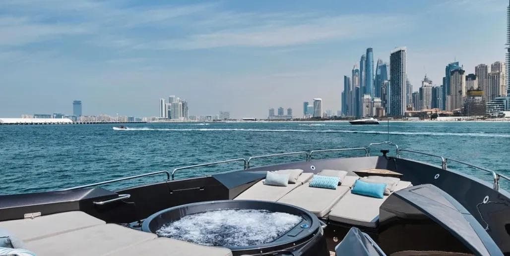 Luxurious Sunseeker Predator 108 yacht with jacuzzi, Dubai skyline in background, 2006 model.