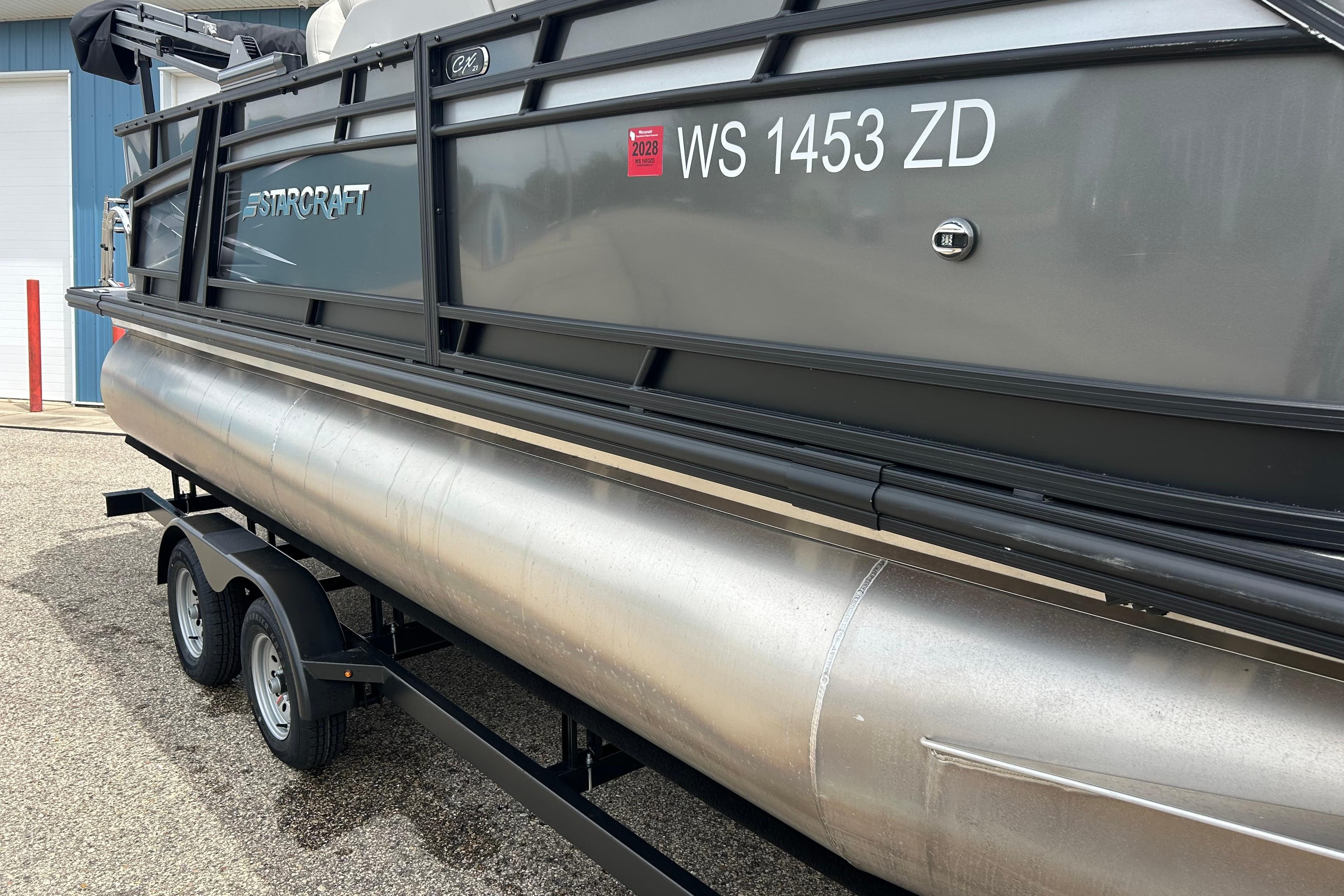 2022 Starcraft CX 21 C pontoon boat on trailer, side view with registration number.