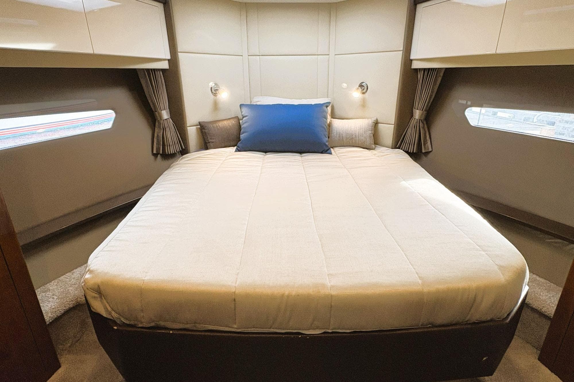 Luxurious bedroom interior of 2016 Carver C40 yacht with cozy bedding and elegant design.