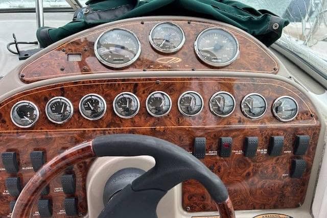 2003 Maxum 2900 SCR boat dashboard with wood finish and multiple gauges.