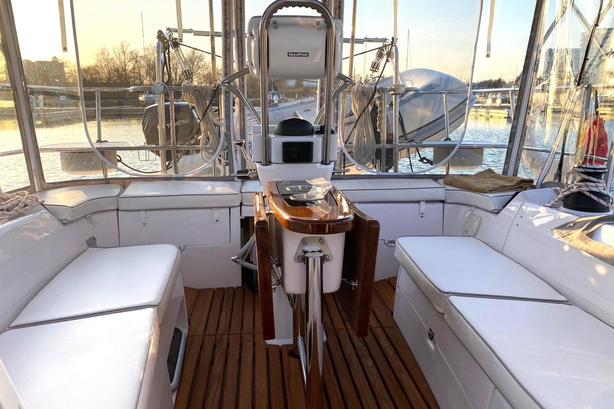 Interior view of a 2022 Catalina 355 sailboat with seating and navigation equipment.