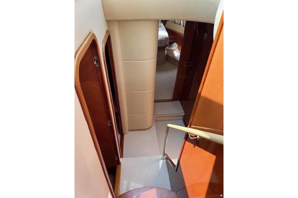 Interior view of 2006 Princess 67 Flybridge Motor Yacht, featuring elegant wood finishes and cozy cabin.