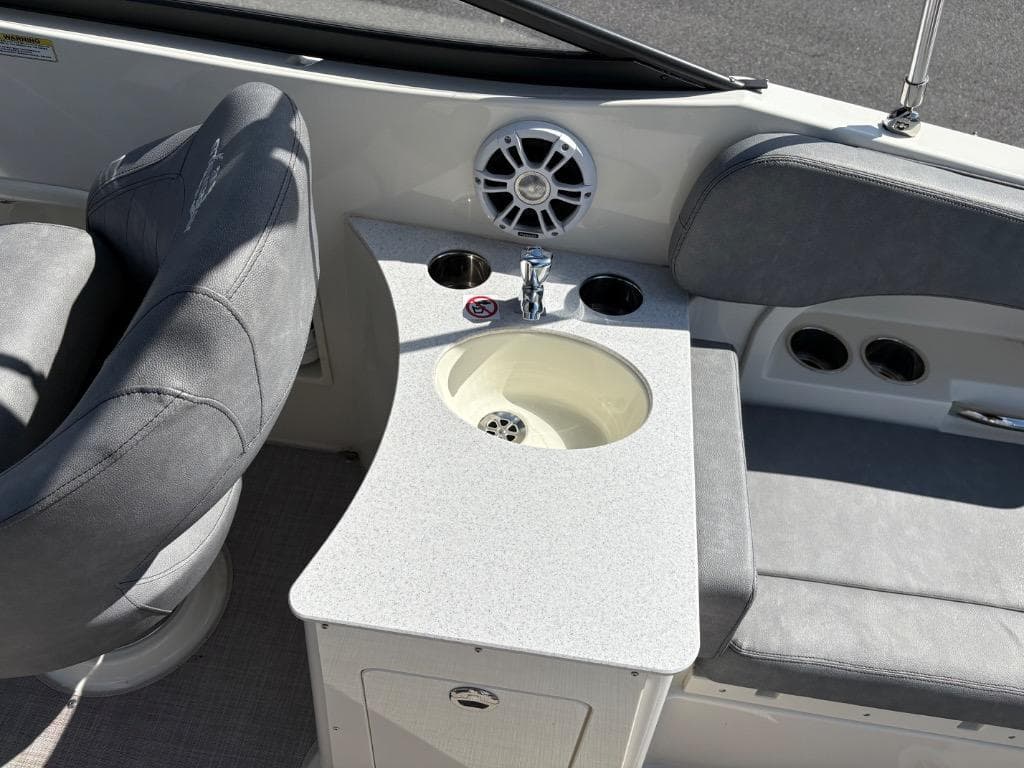 2021 Stingray 231 DC boat interior with seating, sink, and speaker.