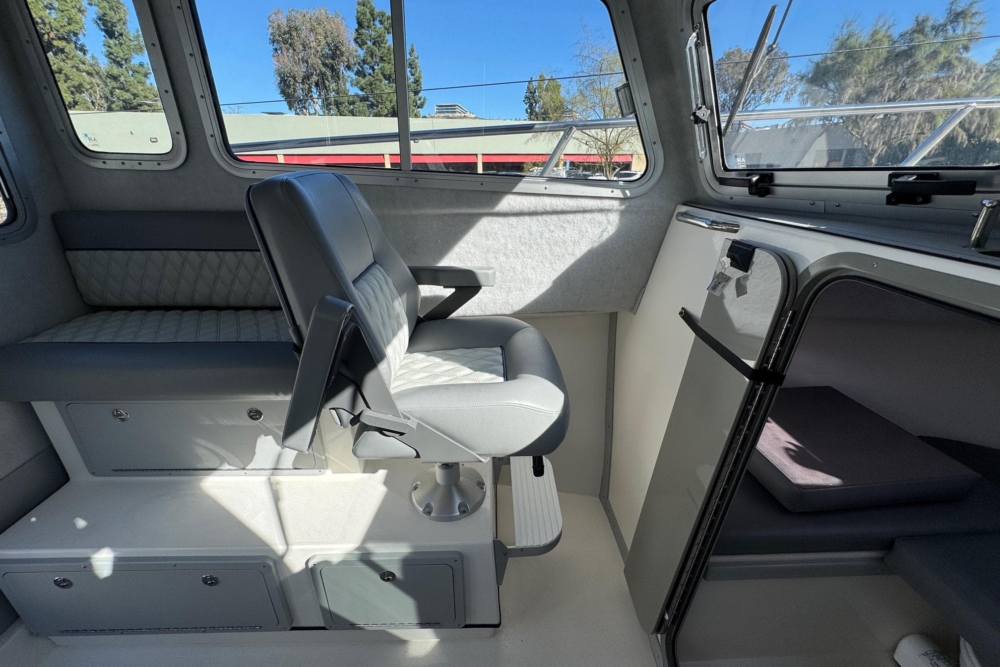Interior of 2026 Defiance Admiral 250 EX boat, featuring seating and cabin area.