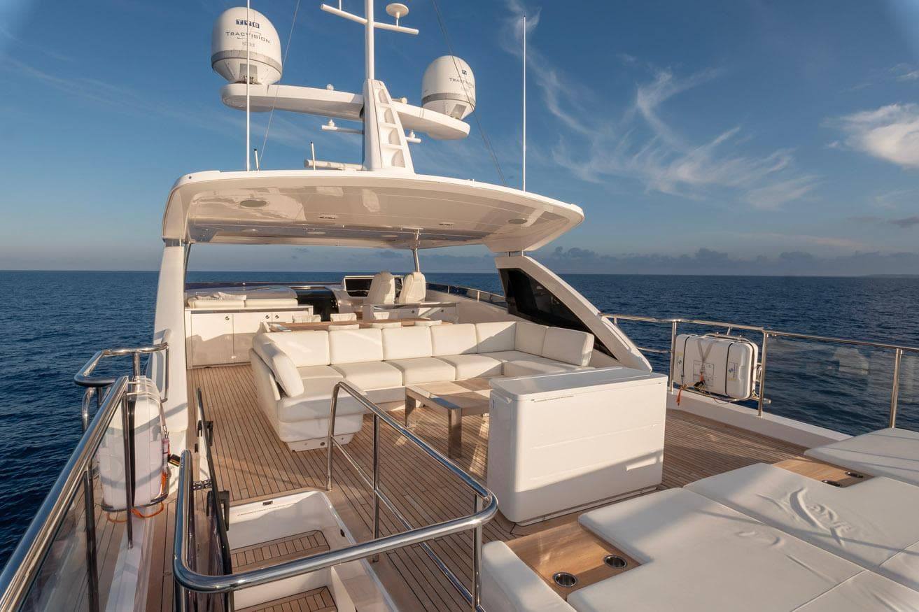 Luxurious 2019 Princess 30M yacht deck with elegant seating, ocean view, and clear sky.