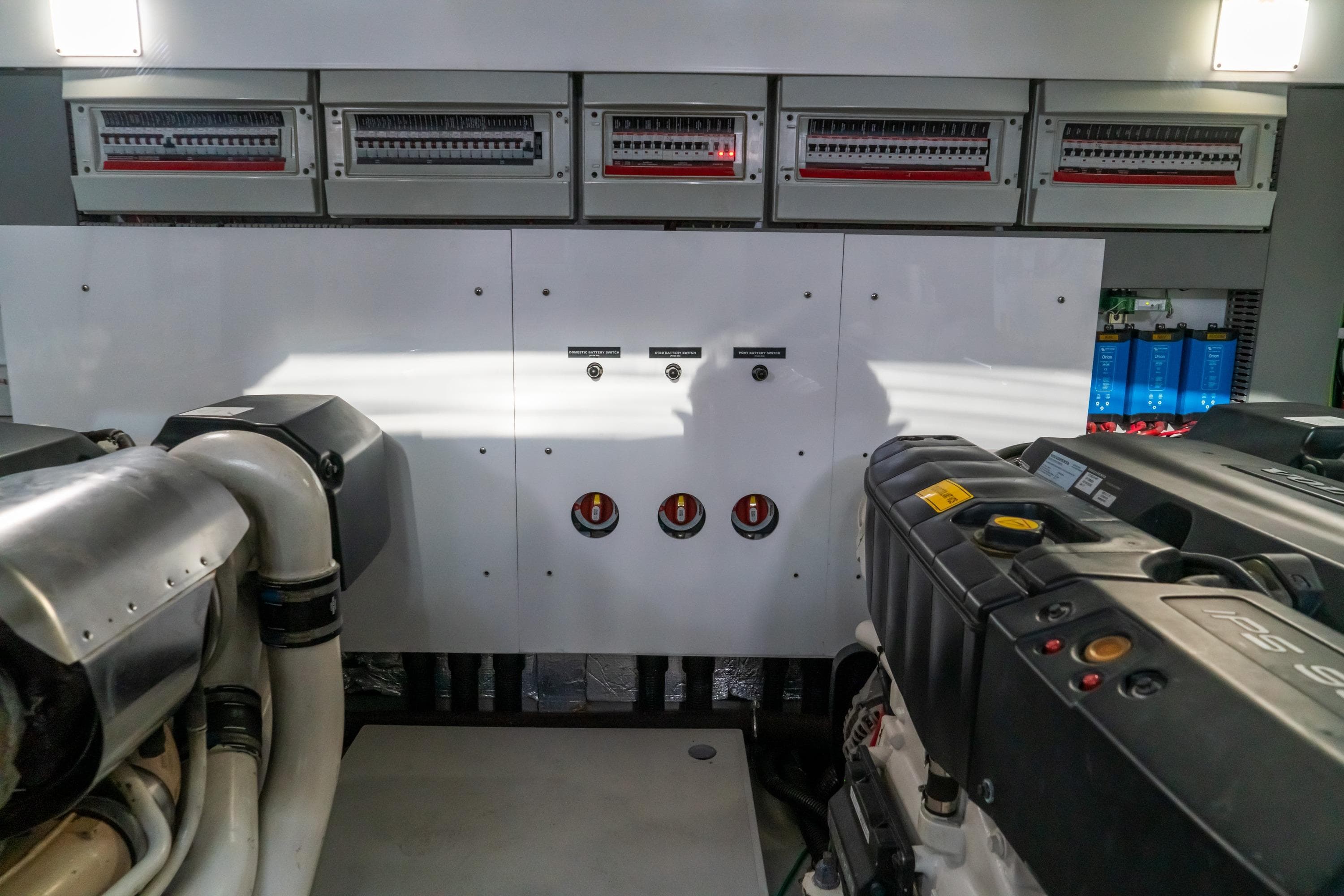 Engine room of 2018 Sunseeker Manhattan 52 yacht, showcasing mechanical components and control panels.