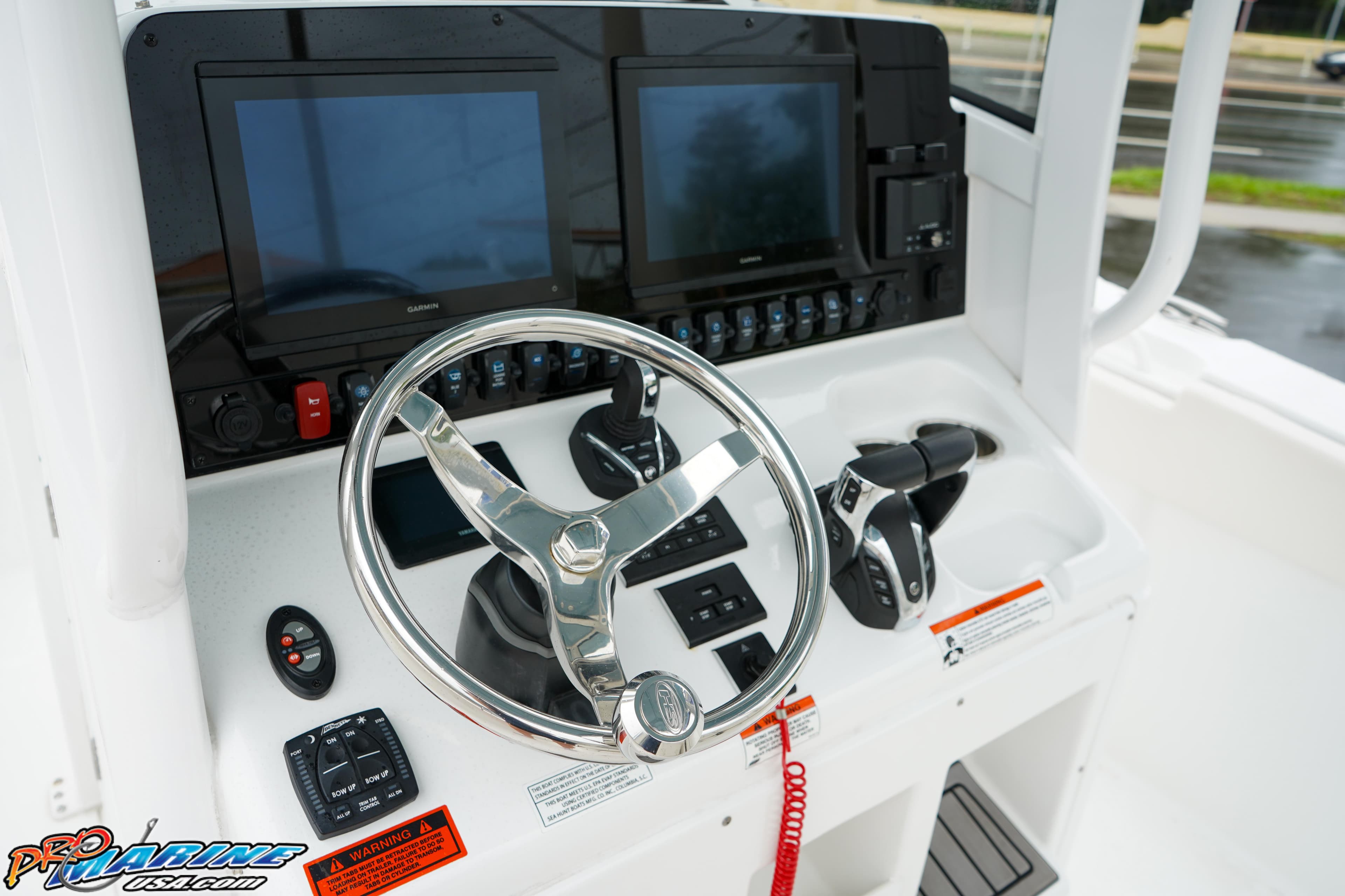 2023 Sea Hunt Ultra 275 SE boat dashboard with dual screens and steering wheel.