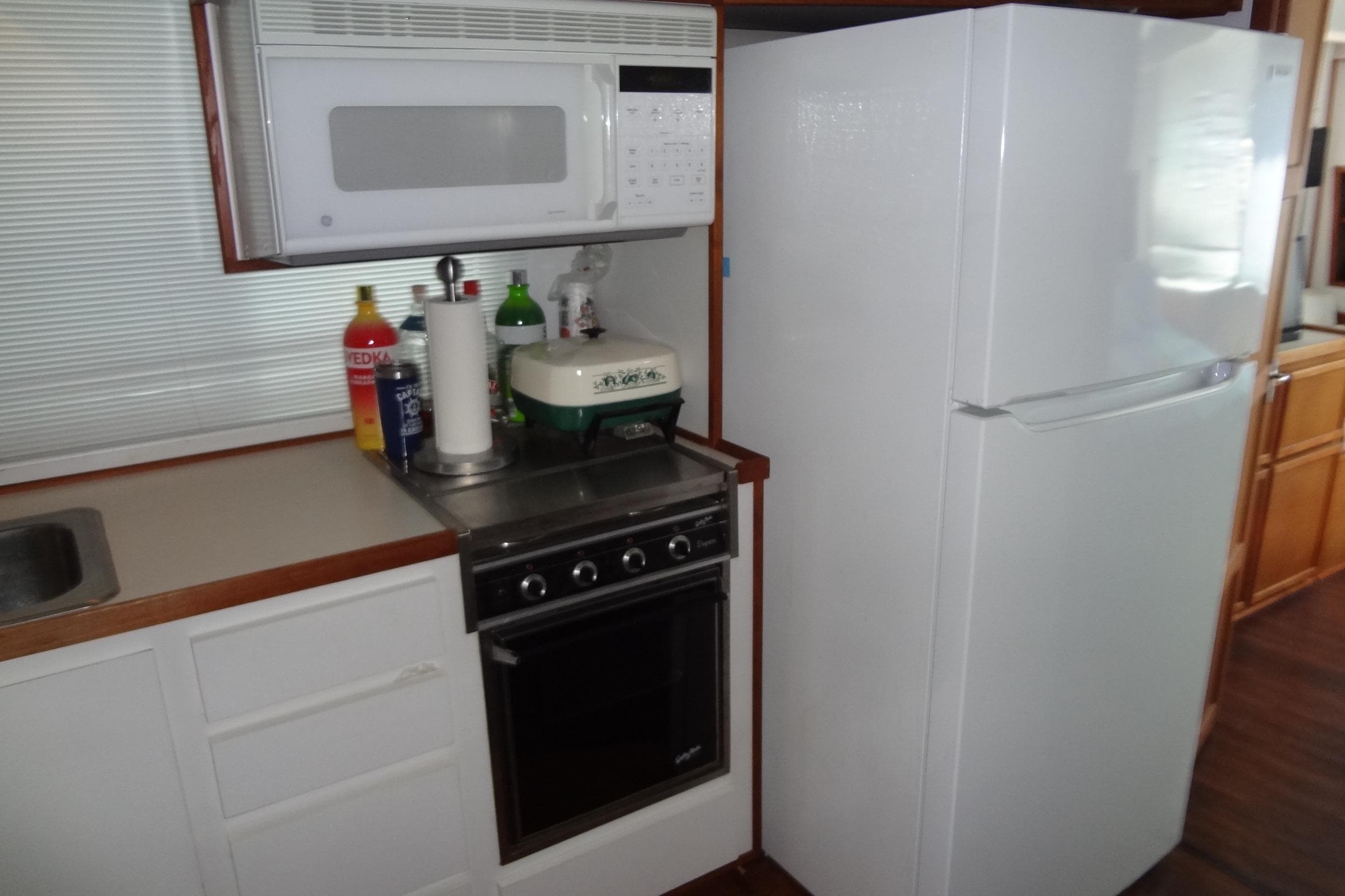 Kitchen area in a 1995 Harbor Master 52 boat with appliances and countertop.