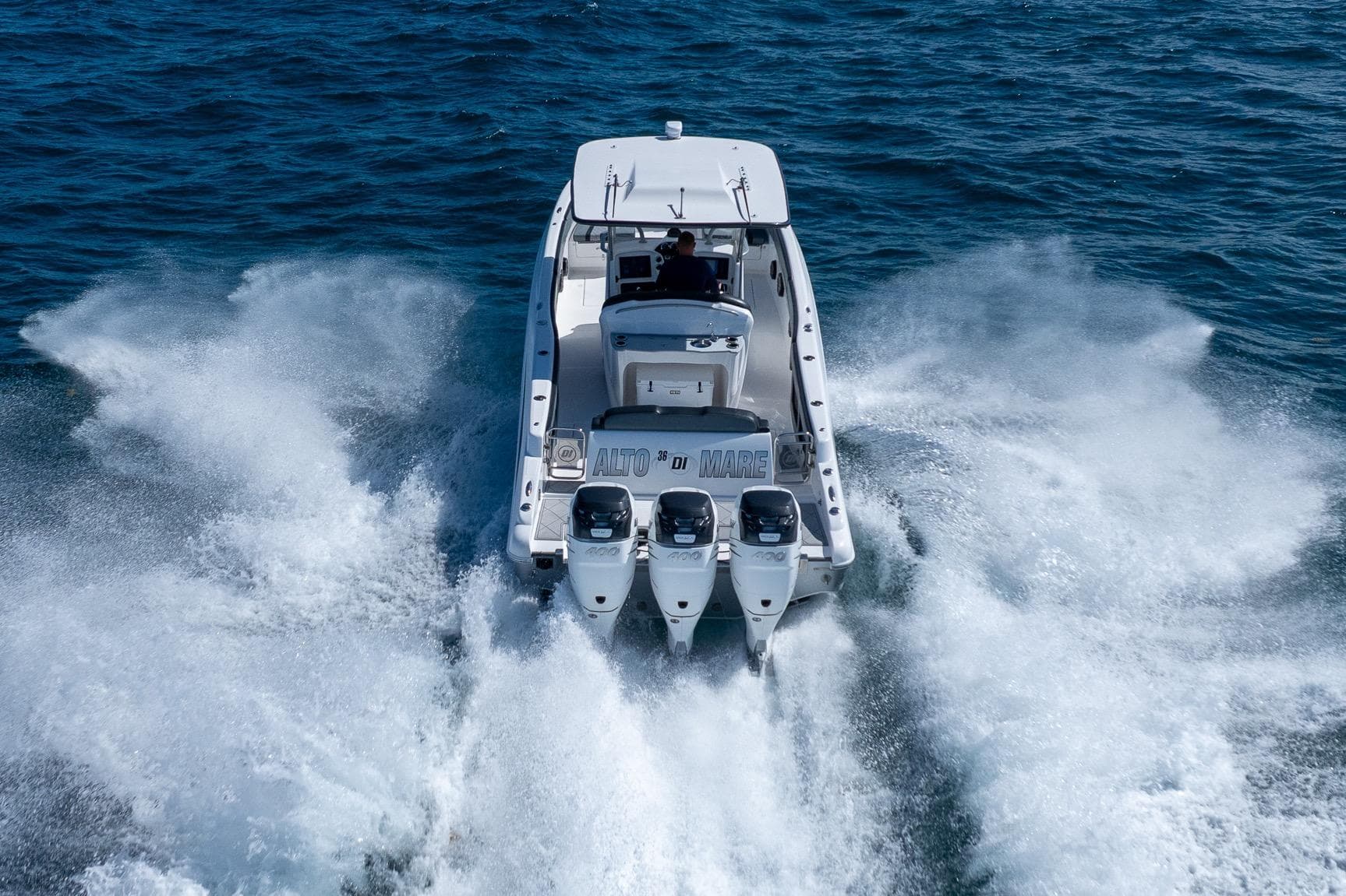 2019 Deep Impact 369 Sport boat speeding on open water, rear view.
