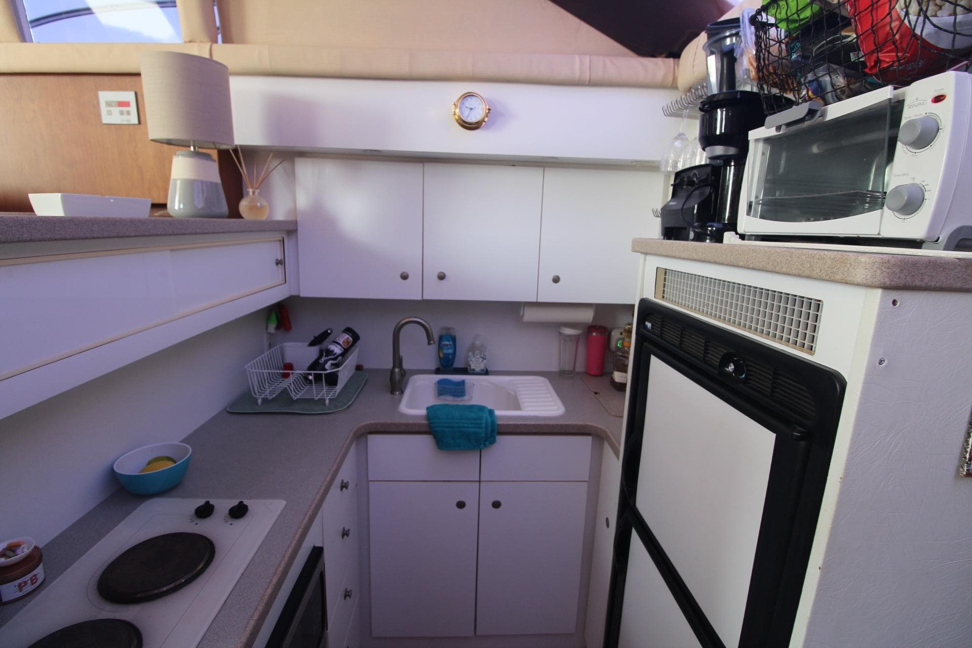 Compact kitchen in a 1996 Silverton 41 Convertible boat with appliances and storage.