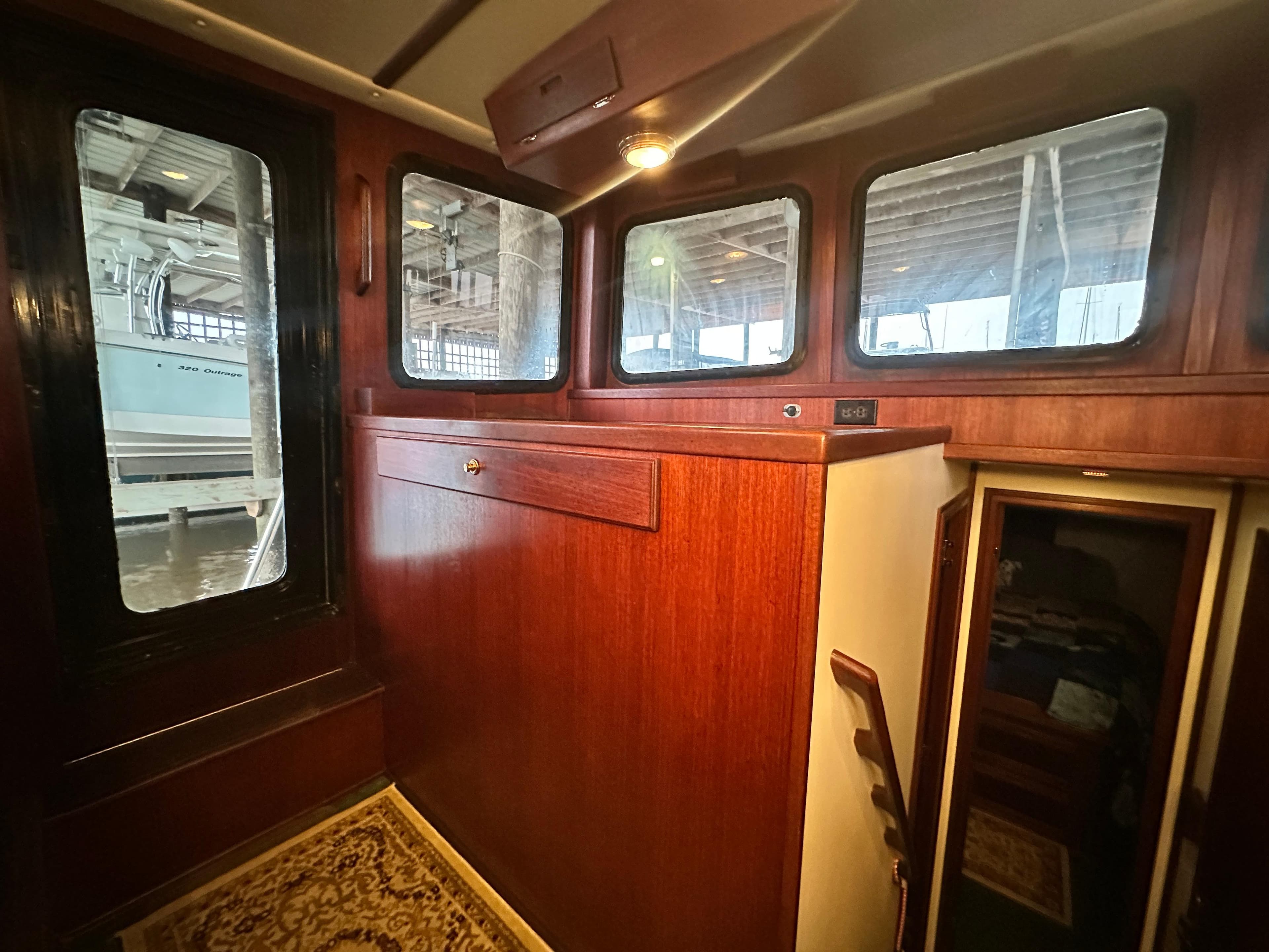 Interior of 2001 Nordic Tug 37, featuring wood paneling and windows.