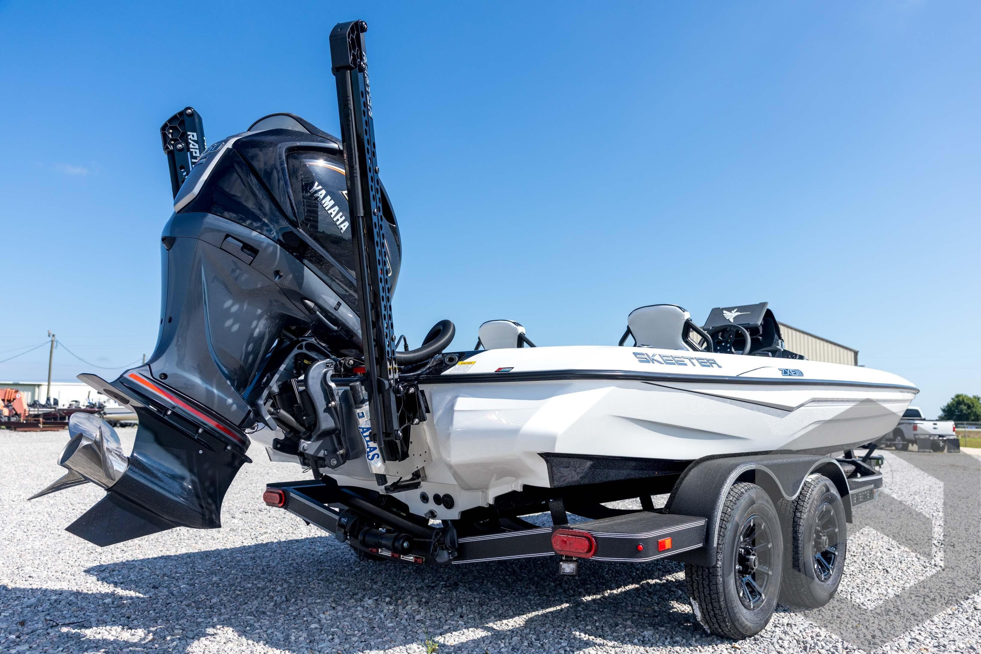 2026 Skeeter ZXE21 boat with Yamaha engine on a trailer, parked outdoors.