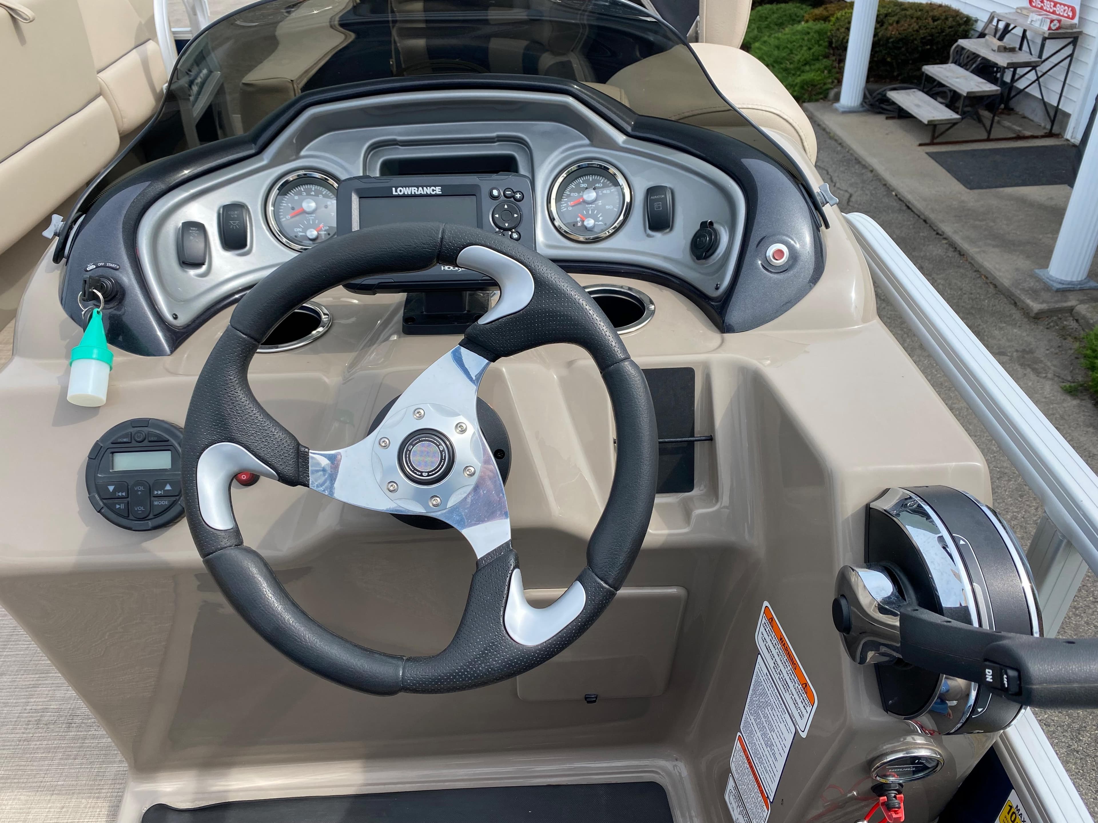 2020 Sun Tracker SportFish 22 DLX boat dashboard with steering wheel and controls.