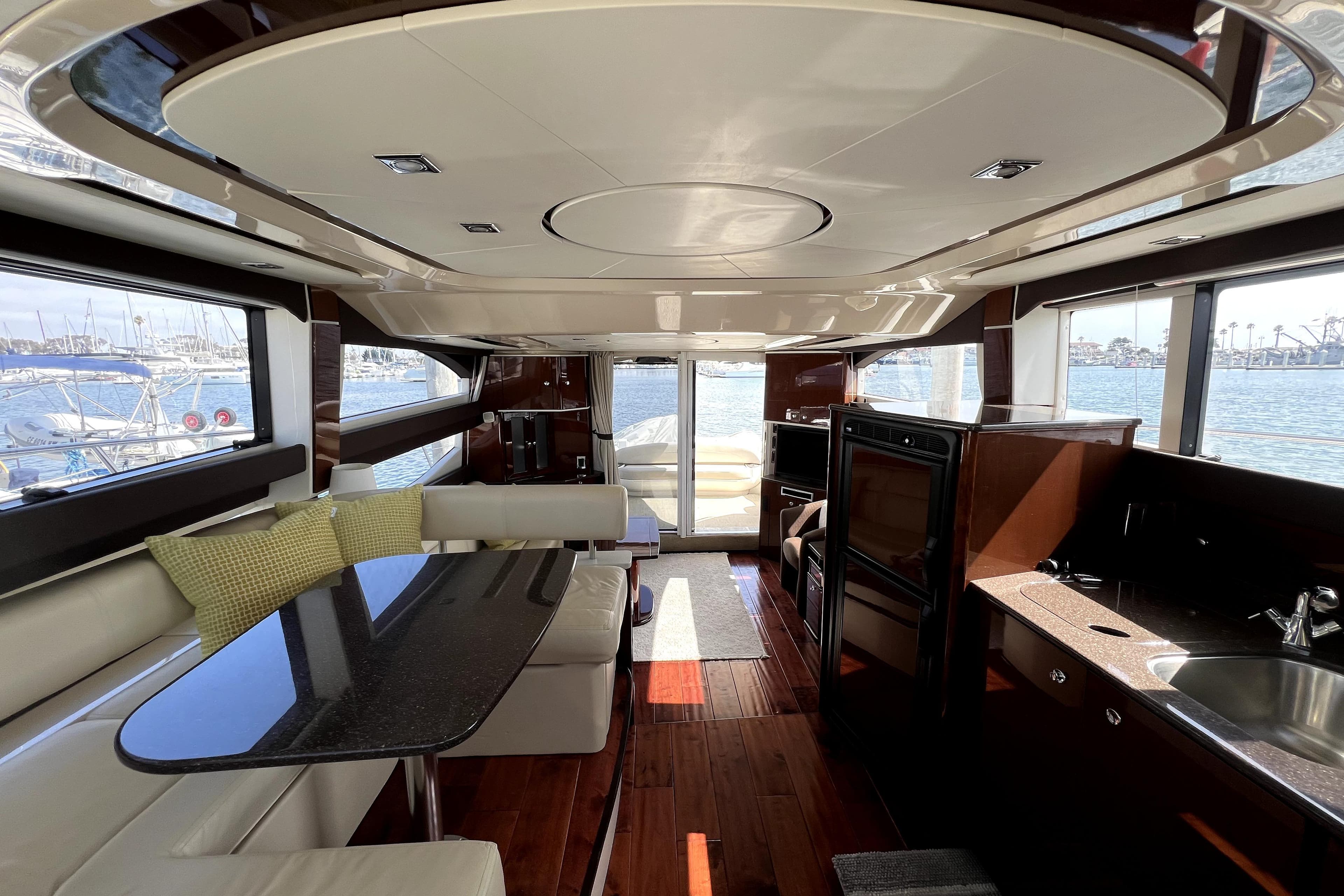 Luxurious interior of 2013 Meridian 441 Sedan yacht with elegant seating and panoramic windows.