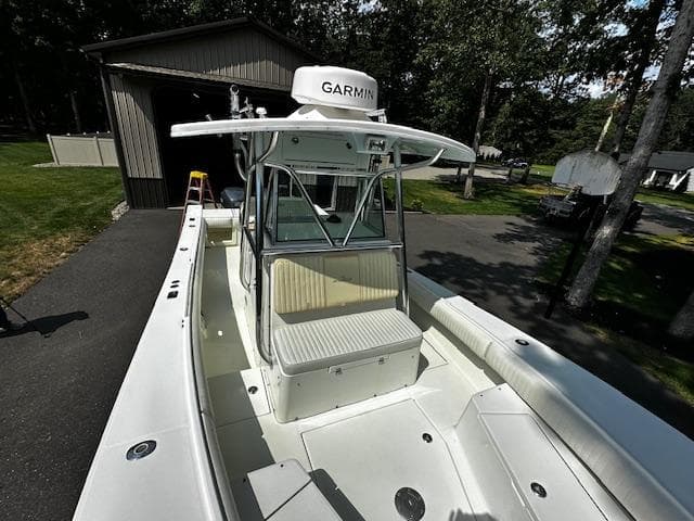 2008 Regulator 29 Forward Seating boat with Garmin equipment, parked near a garage.