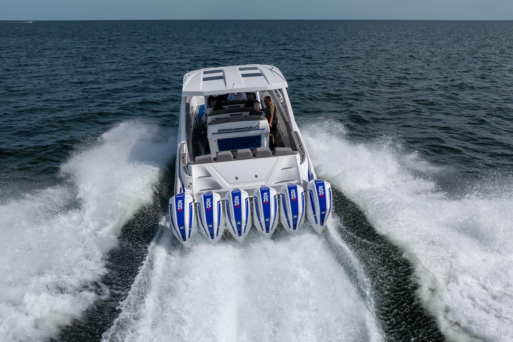 2027 Deep Impact 449 Sport boat with multiple engines cruising on open water.