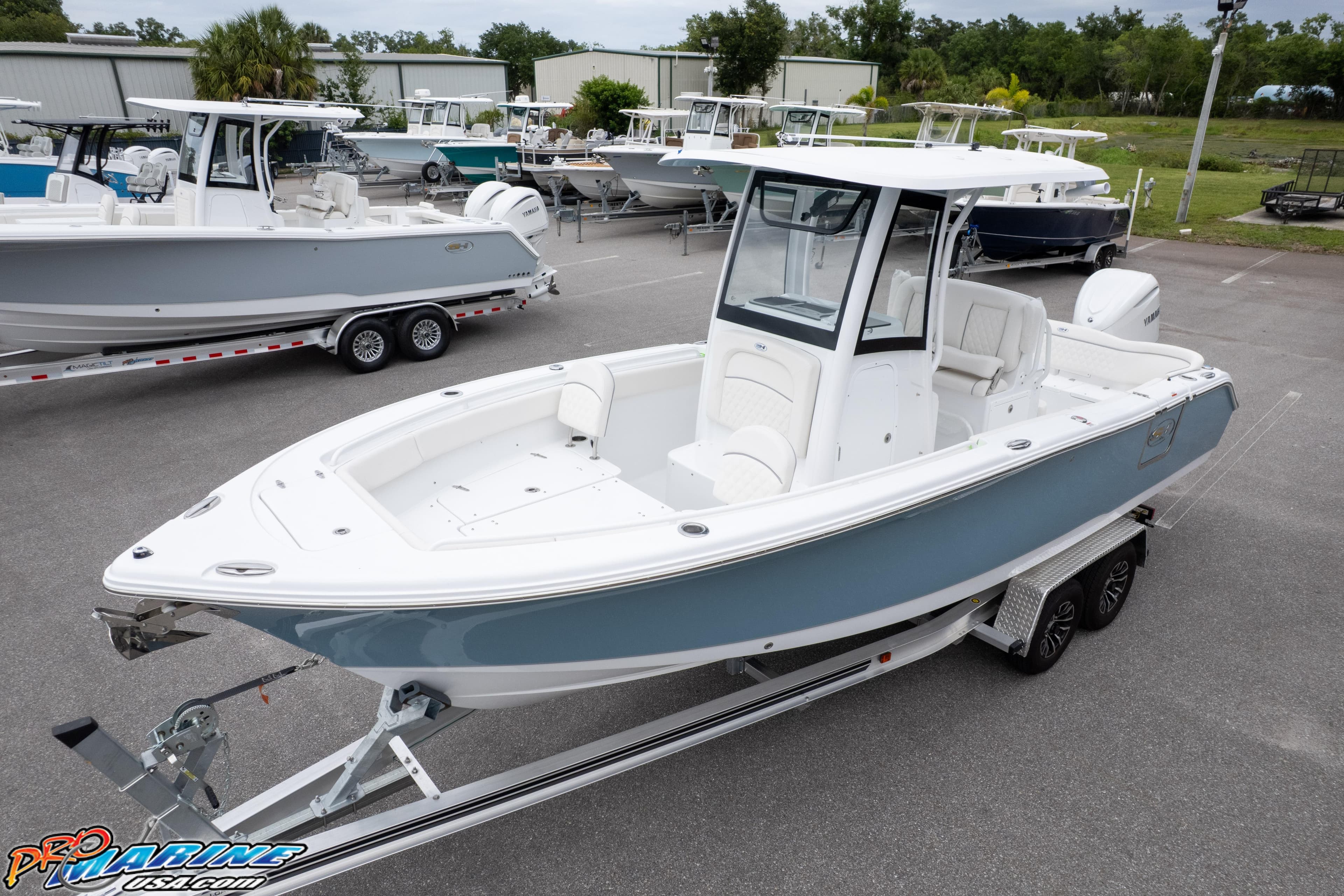 2027 Sea Hunt Ultra 255 SE boat on trailer in marina parking lot.