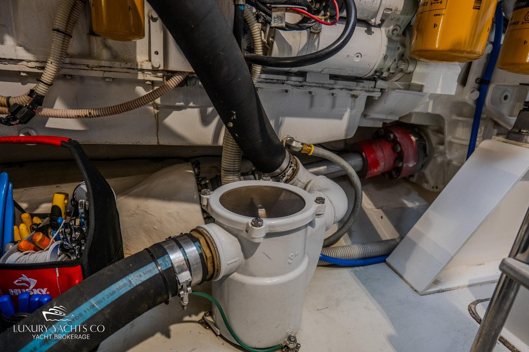 Engine room of 2010 Azimut 62S yacht with visible hoses and components.