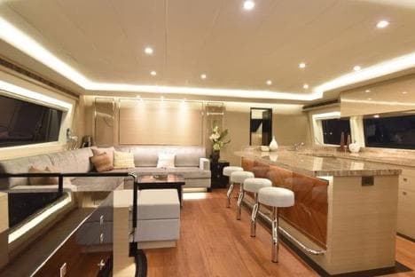 Luxurious interior of 2022 Horizon PC65 yacht with modern seating and elegant lighting.