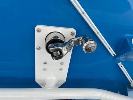 Chrome handle on 2022 Yellowfin 39 Offshore boat against blue background.