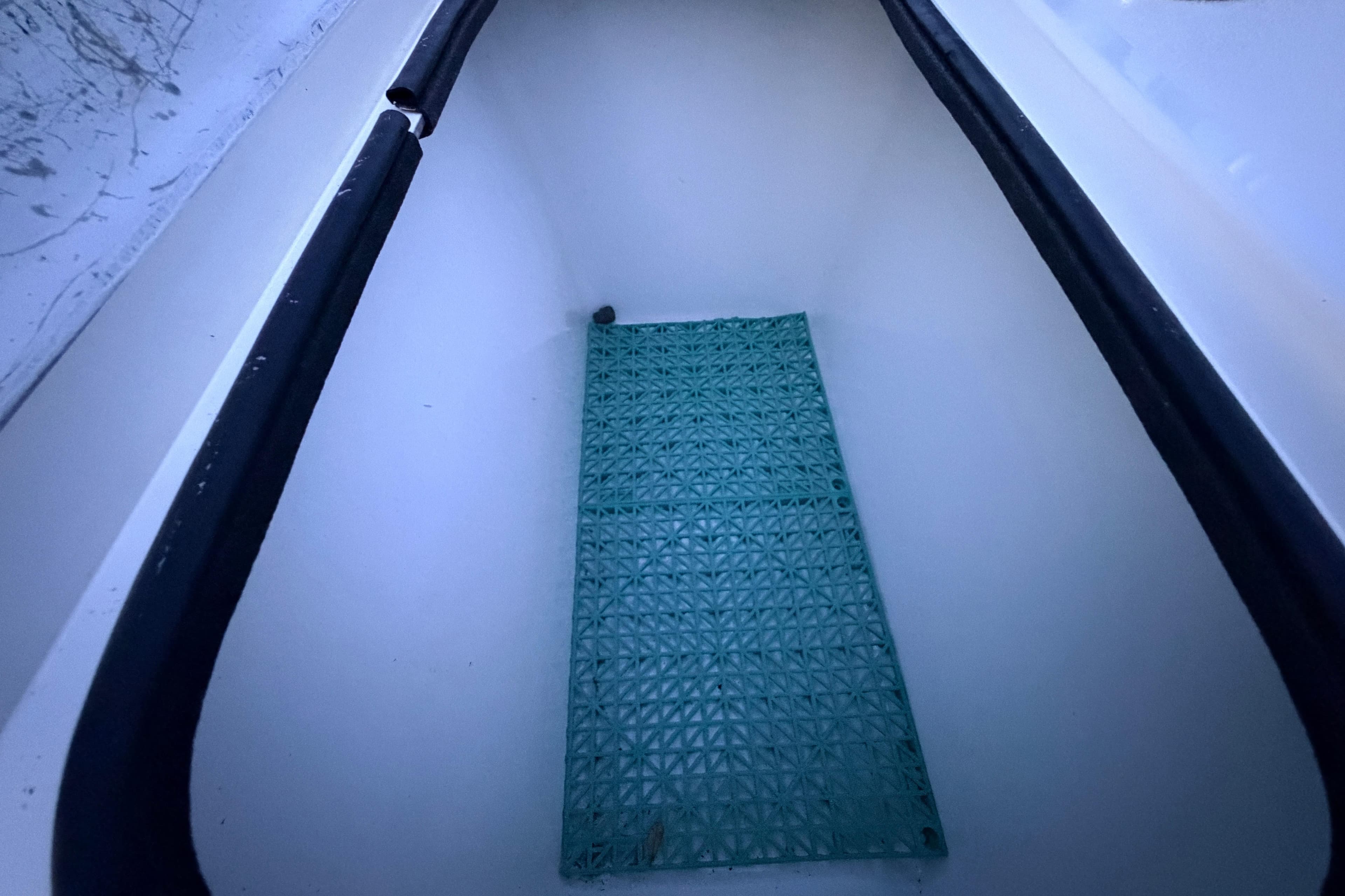 Interior view of a 2019 Mitzi Skiffs 17 boat compartment with a green mat.