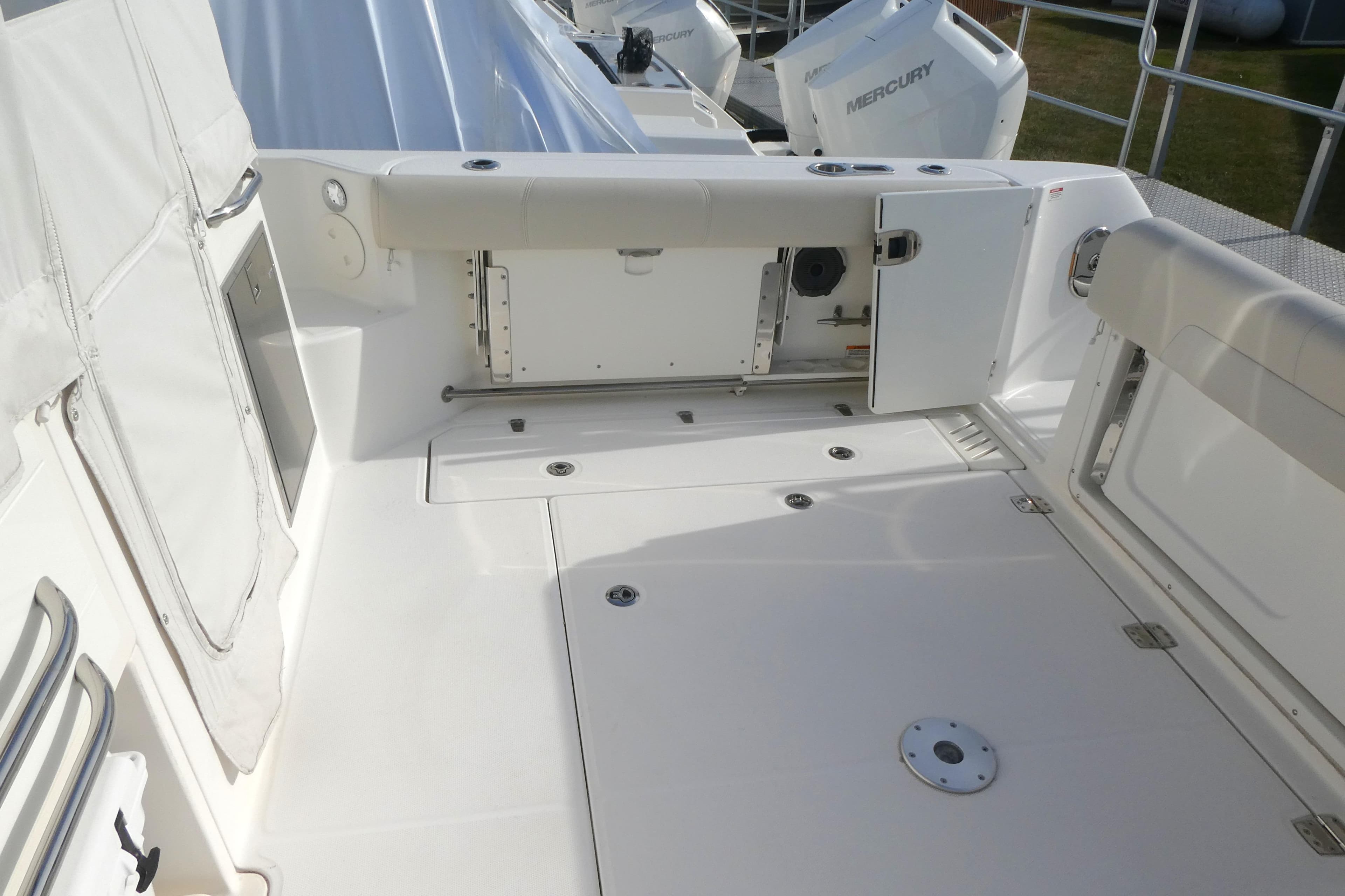 2020 Boston Whaler 345 Conquest boat deck with storage compartments and Mercury engines.