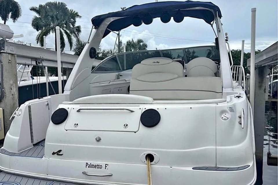 2001 Sea Ray 340 Sundancer yacht docked, featuring sleek design and comfortable seating.
