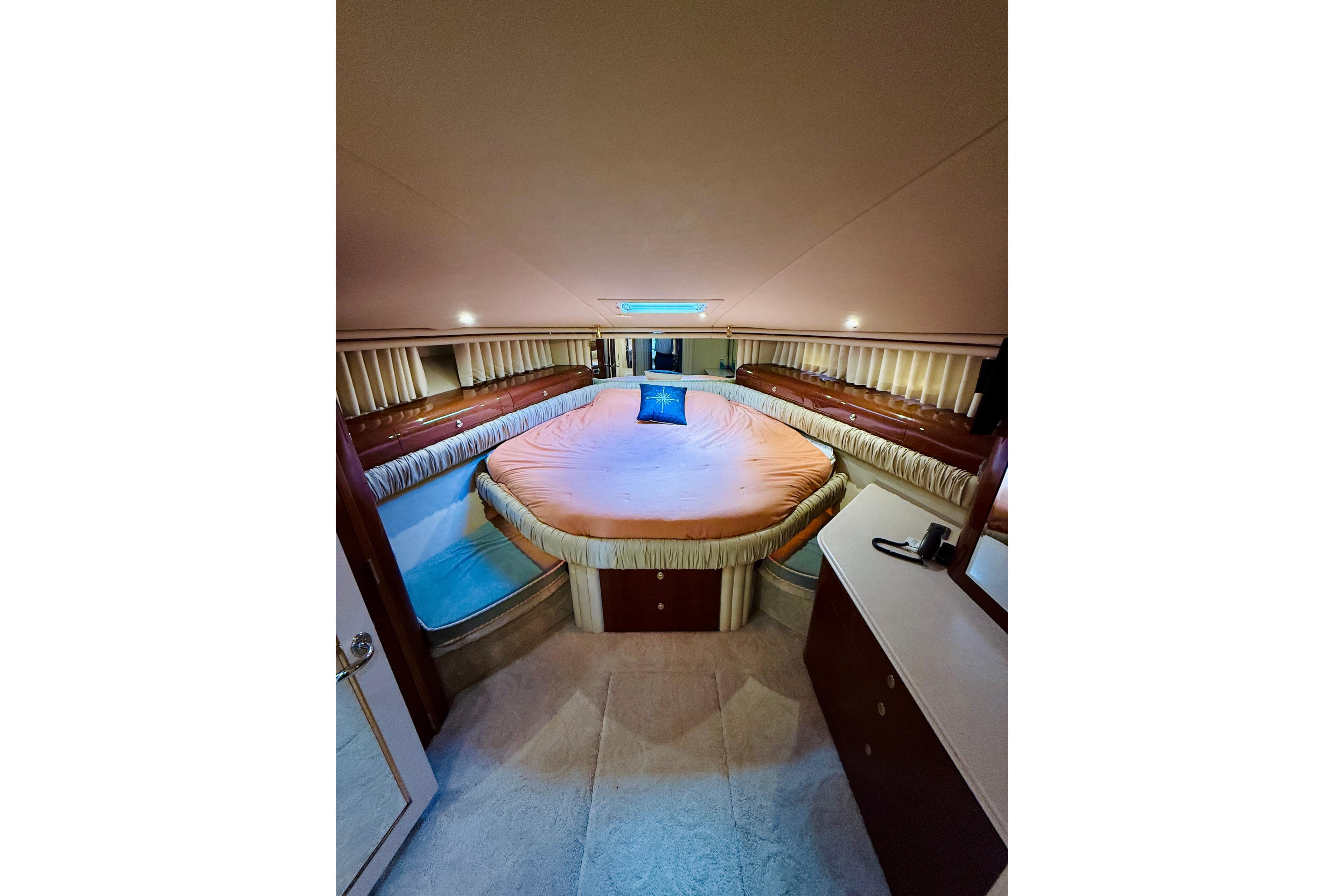 Luxurious 2003 Sea Ray 560 Sedan Bridge yacht bedroom interior with elegant bedding.