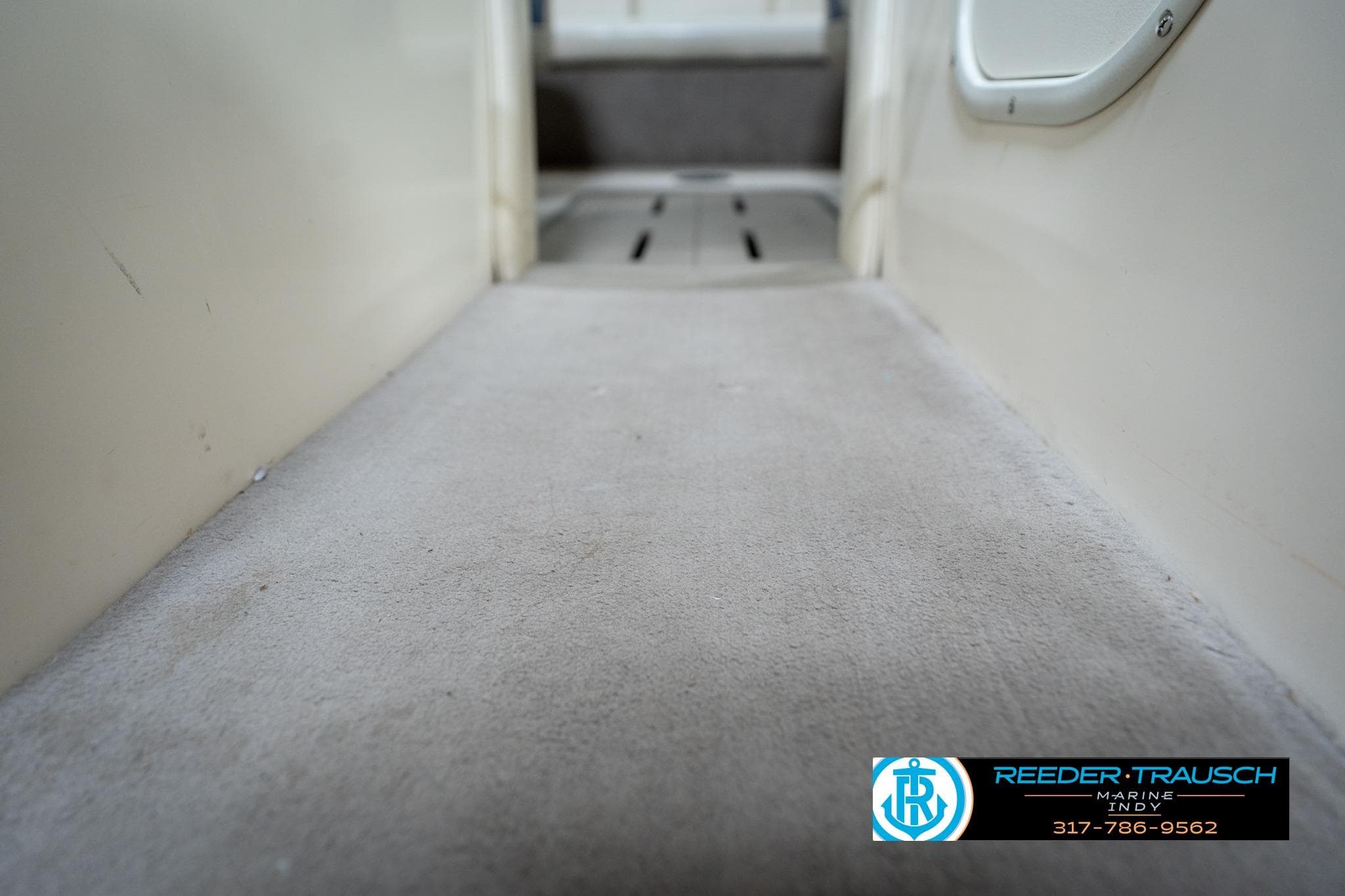 Interior view of a 2000 Bryant 196 Limited boat, featuring carpeted flooring.