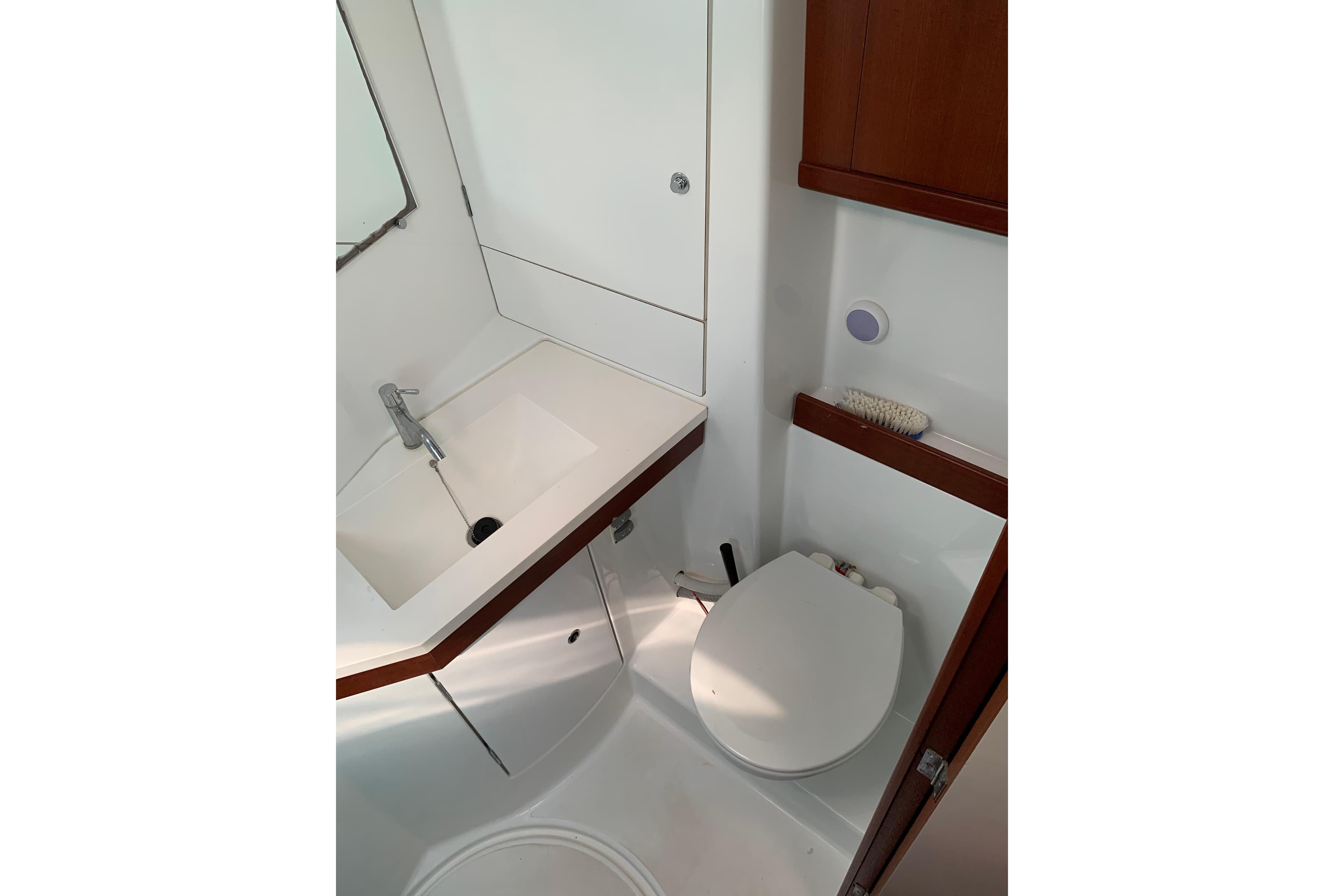 Bathroom interior of 2006 Beneteau Oceanis 50 yacht, featuring sink and toilet.