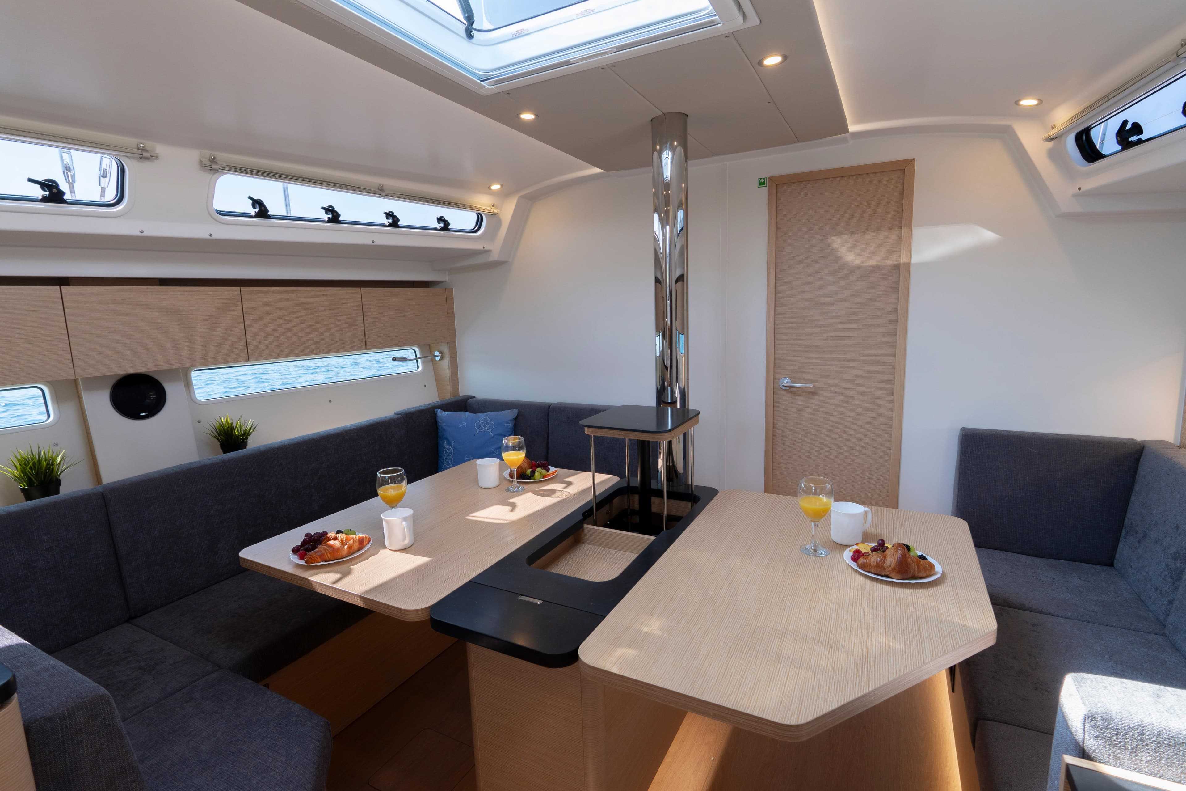Modern interior of 2025 Hanse 410 yacht with dining area and skylight.