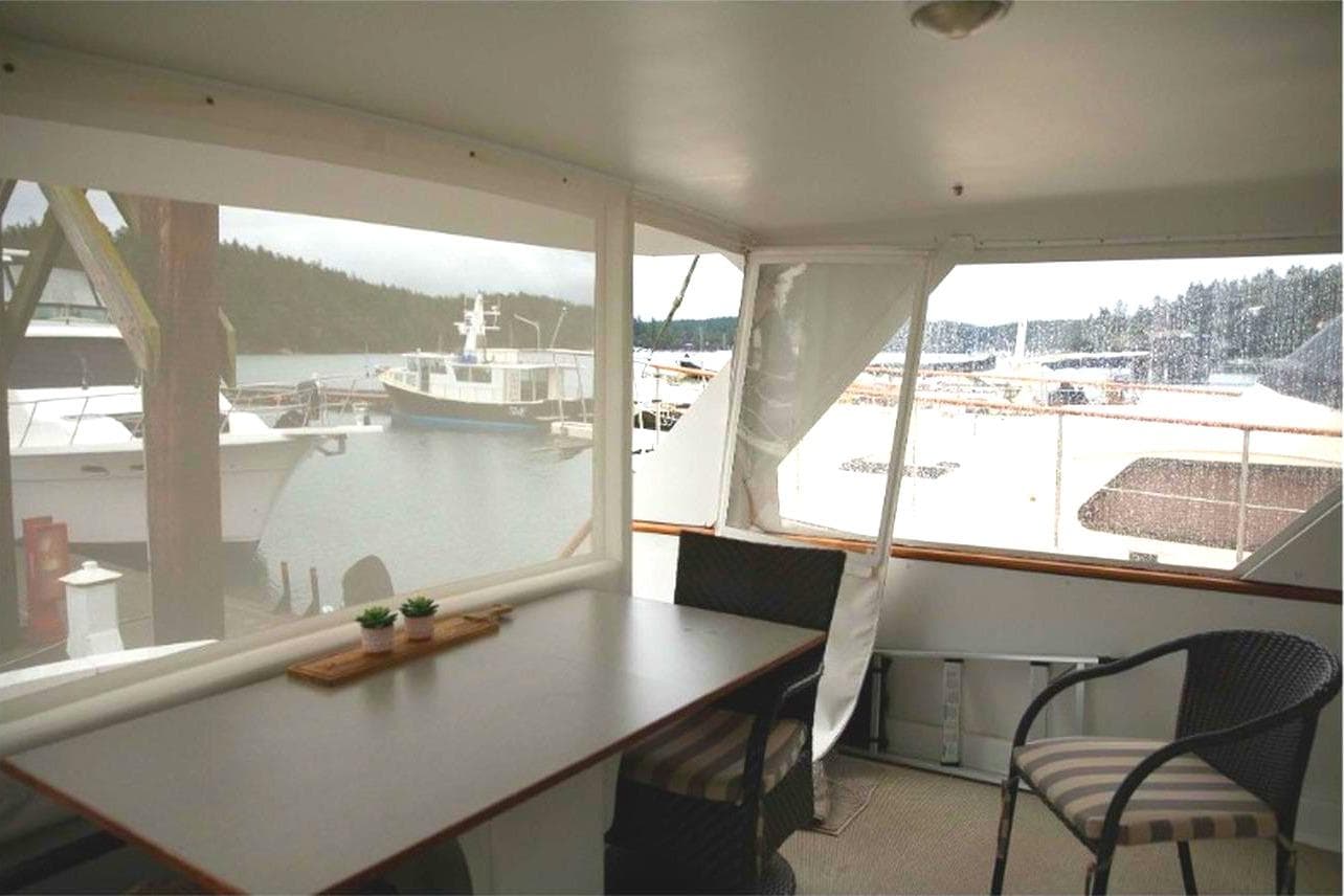 1977 Hatteras 58 Yacht Fisherman interior with marina view through windows.