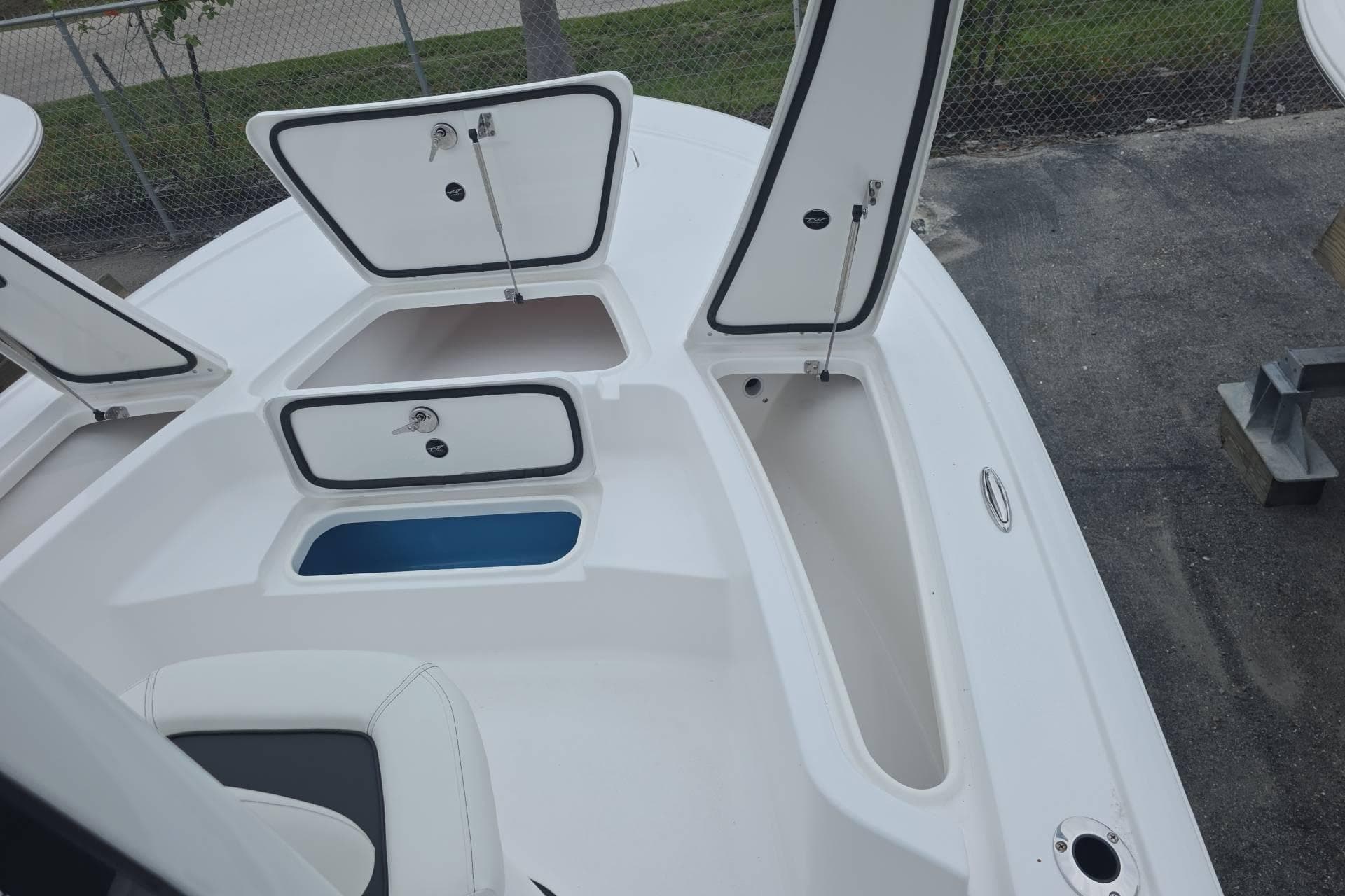 2026 Tidewater 2110 Bay Max boat with open storage compartments on deck.