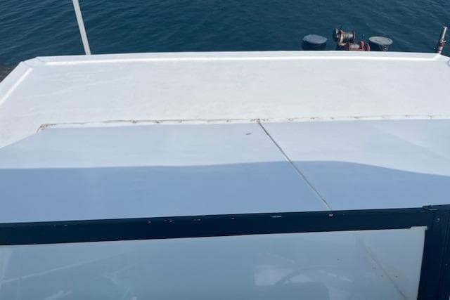 Rooftop view of a 1992 Lakeview Houseboat on calm water.