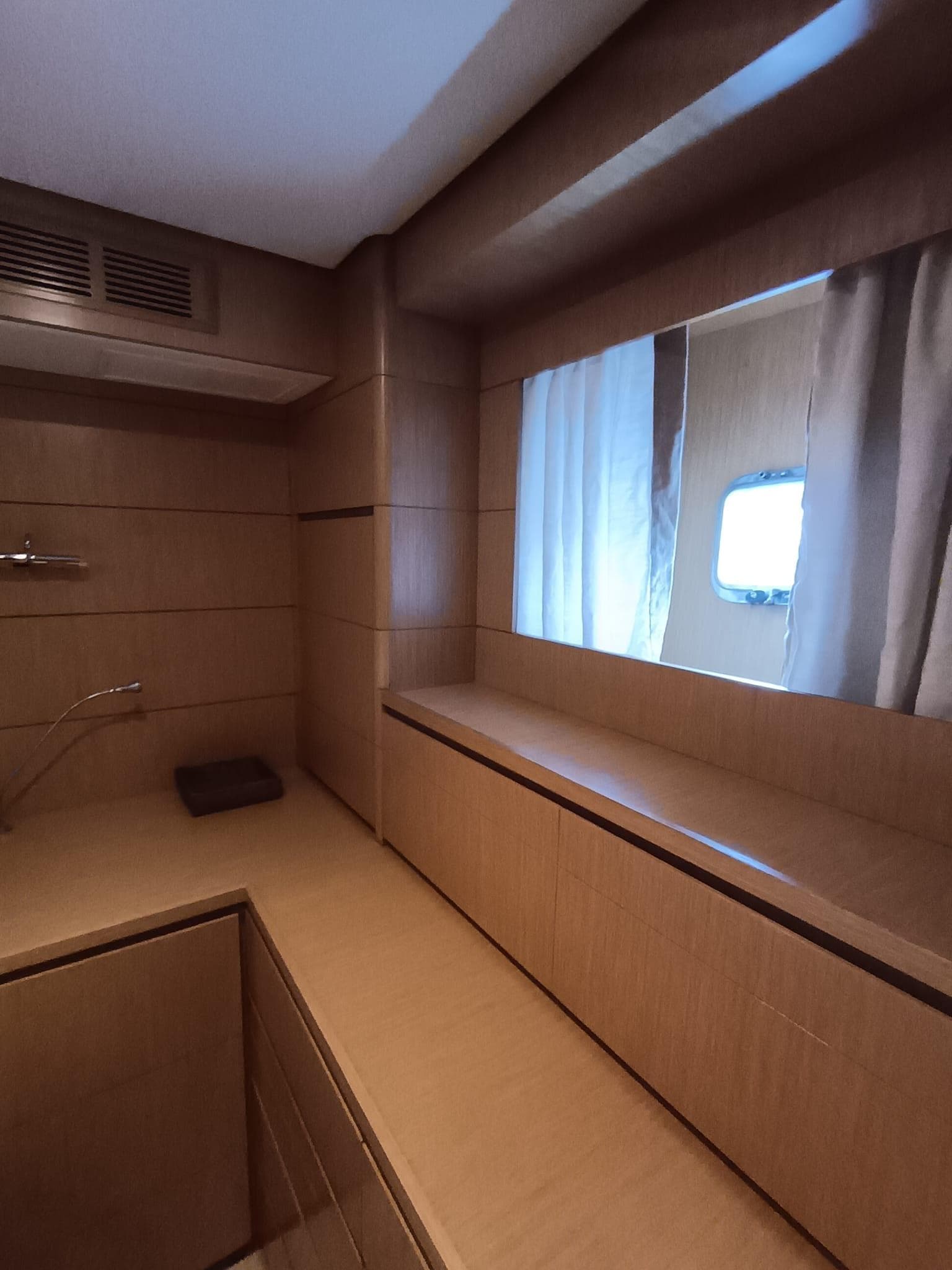 2007 Grand Banks 59 Aleutian RP interior with wooden cabinetry and window.