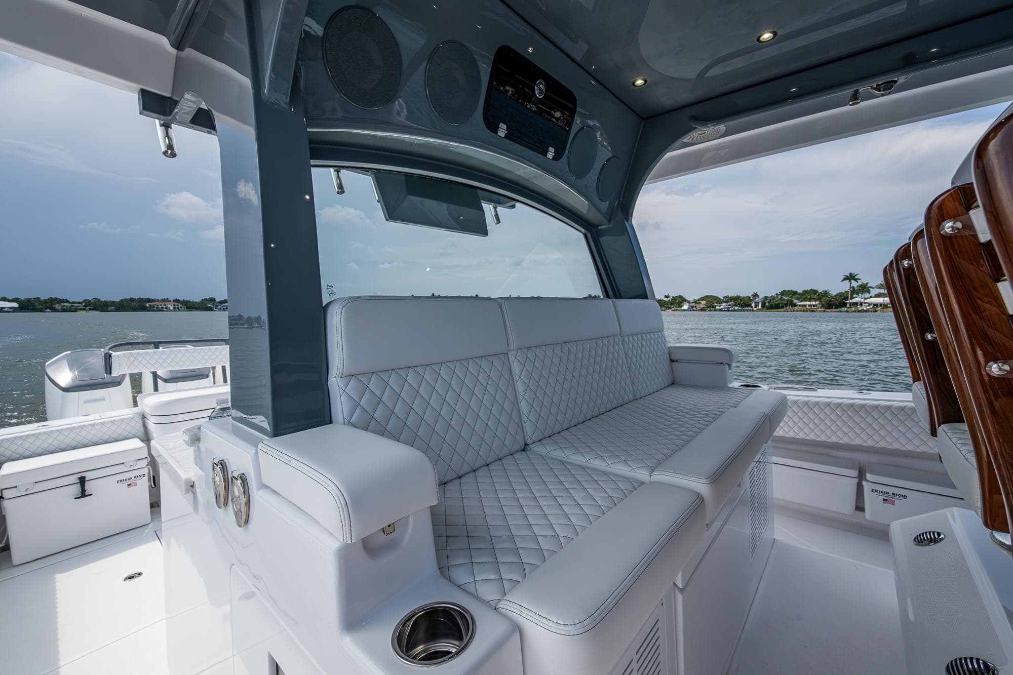 Luxurious seating on 2025 HCB 48 Campeon boat with quilted upholstery and scenic water view.
