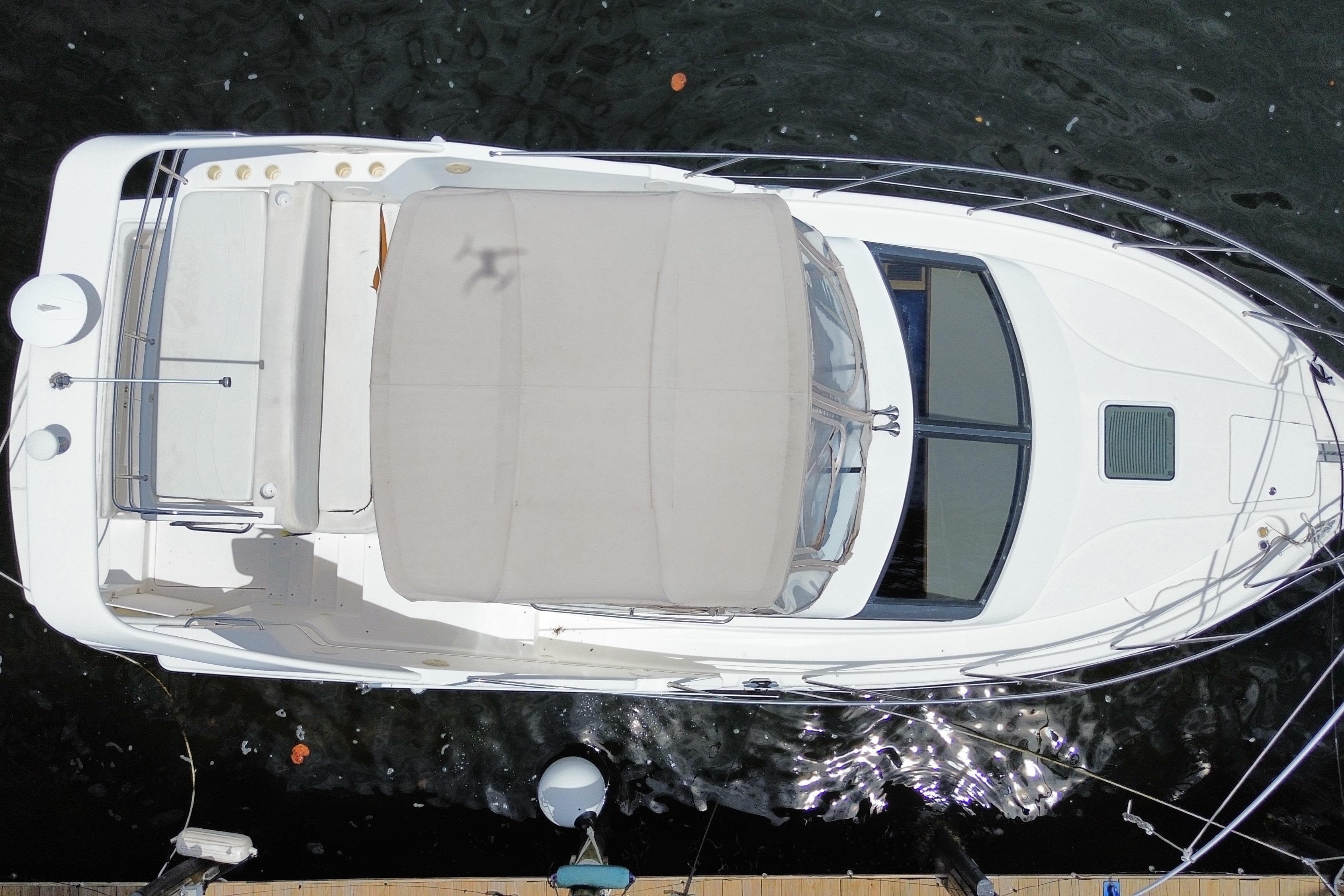 Overhead view of a 2002 Silverton 330 Sport Bridge yacht docked on water.