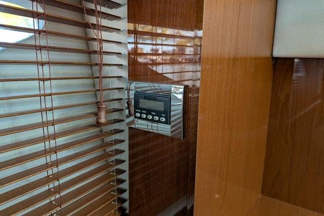 Control panel on 2013 Sea Ray 470 Sundancer yacht, next to wooden blinds.