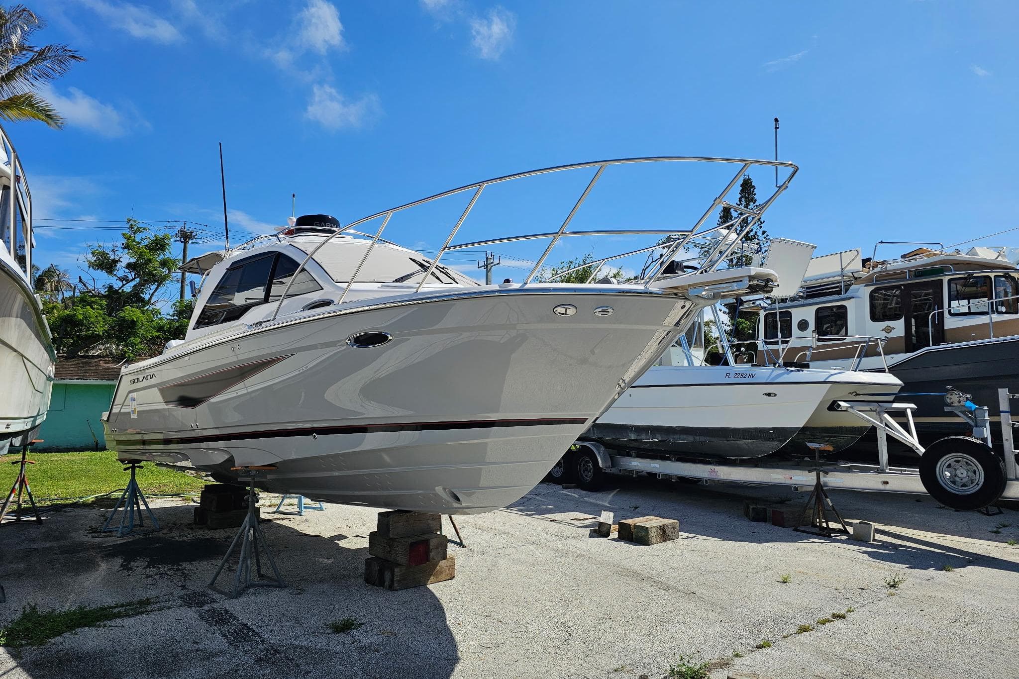 2026 Solara S-250 Coupe boat on dry dock under clear blue sky.