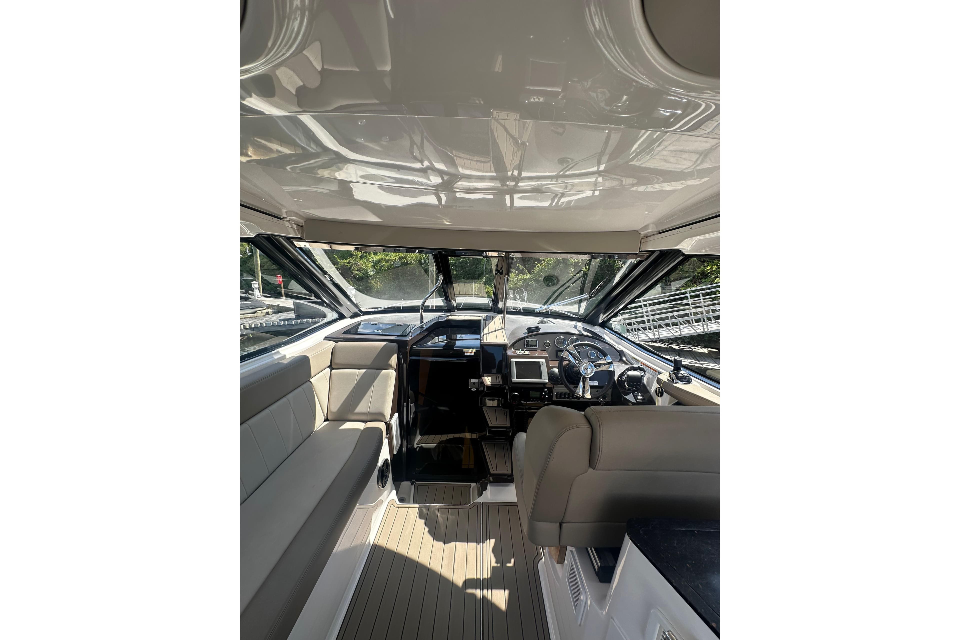 Interior view of 2014 Regal 35 Sport Coupe boat cockpit with seating and controls.
