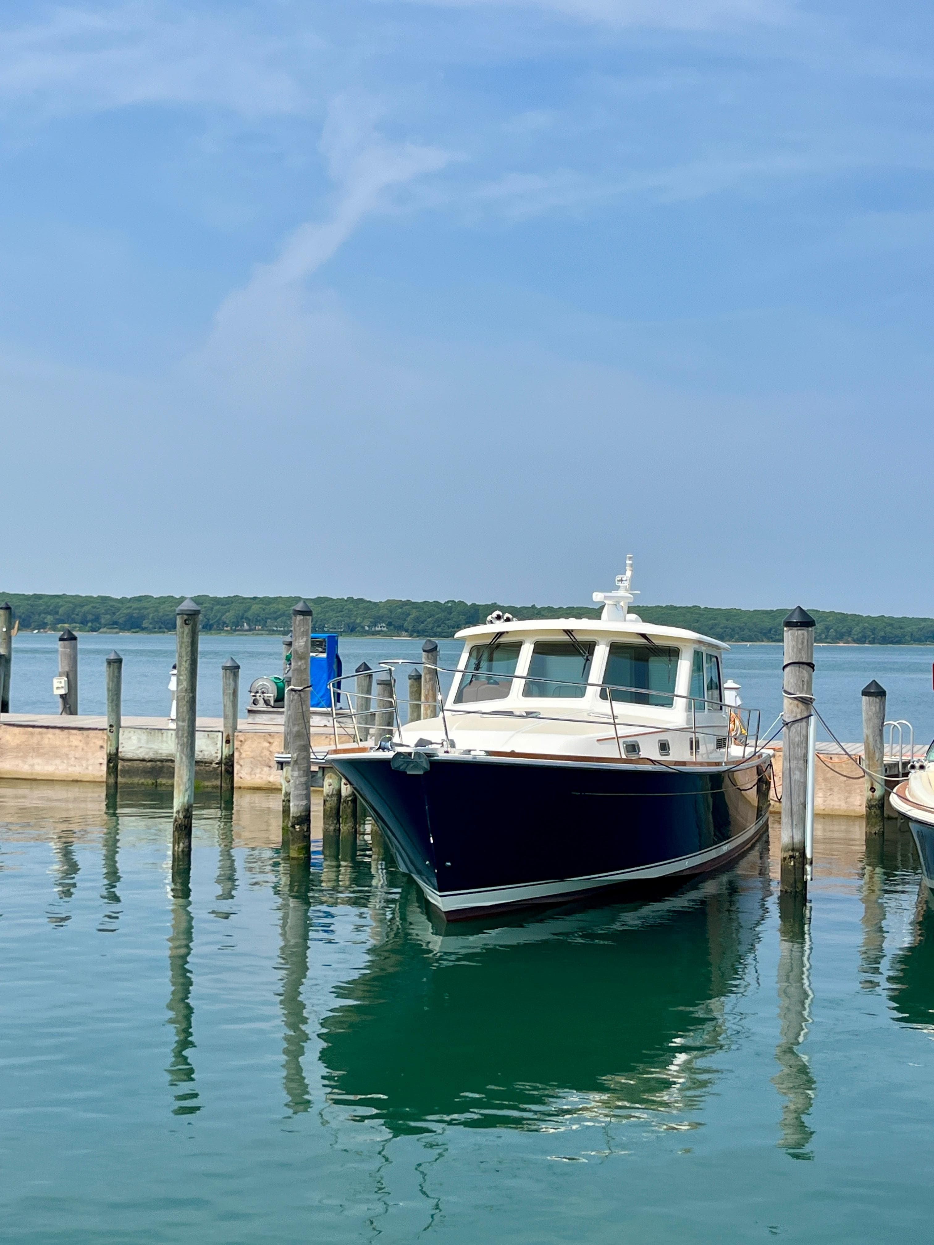 2010 Sabre 40 Sedan docked at a marina on a sunny day.