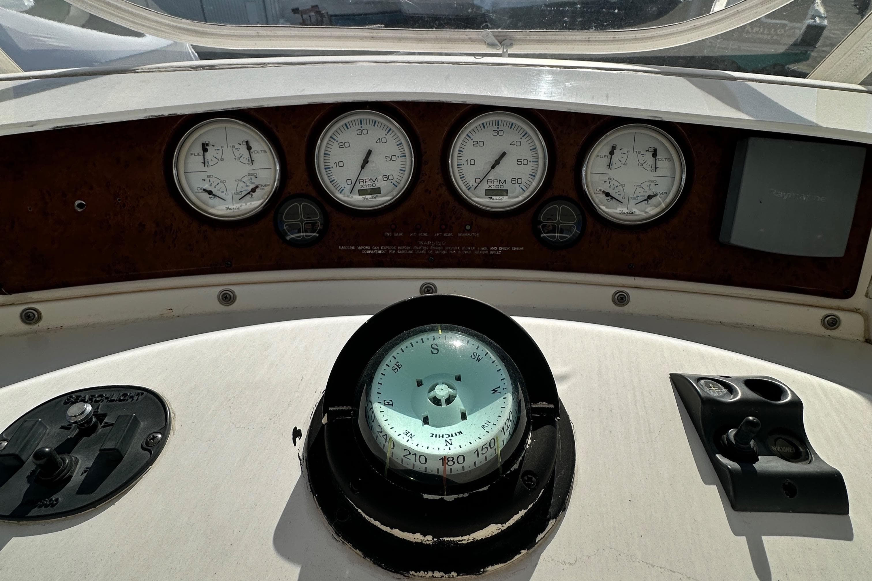 Control panel of 2005 Silverton 34 Convertible boat with compass and gauges.