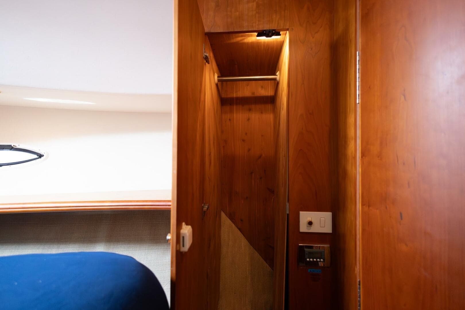 Interior of 2001 Silverton 410 Sport Bridge, featuring wooden closet and control panel.