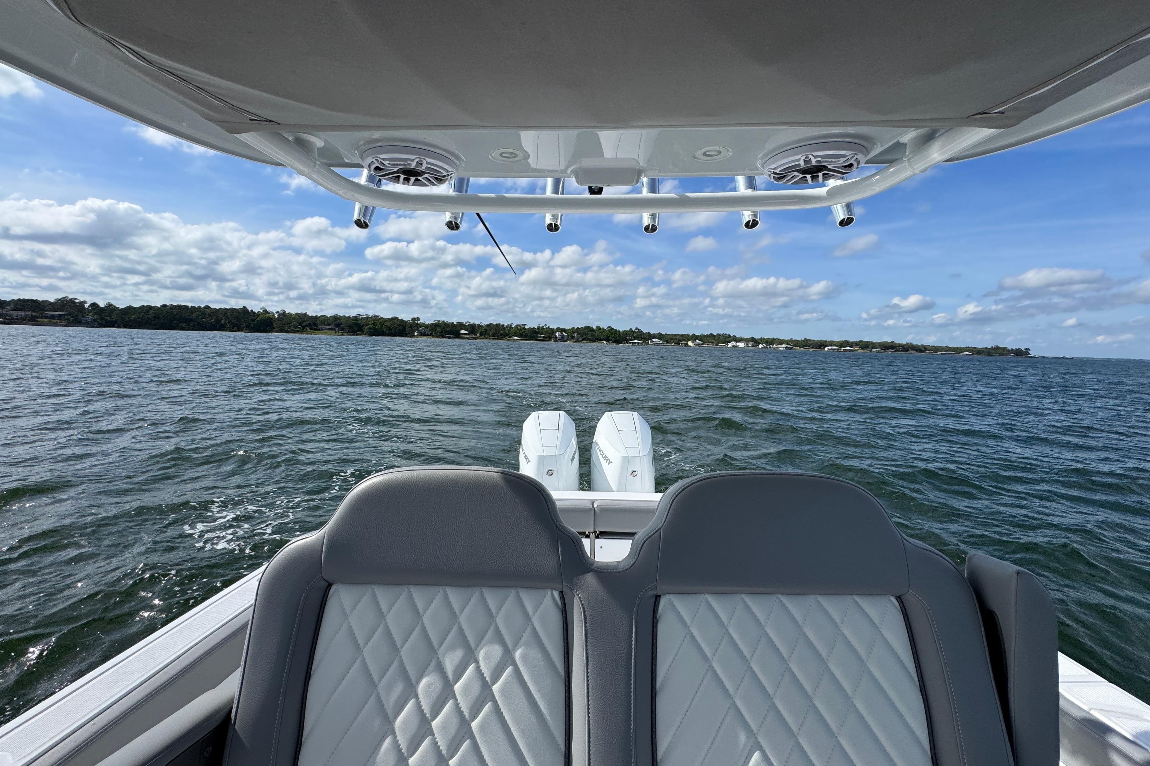 2025 Everglades 315 Center Console boat on open water, featuring dual engines and luxury seating.